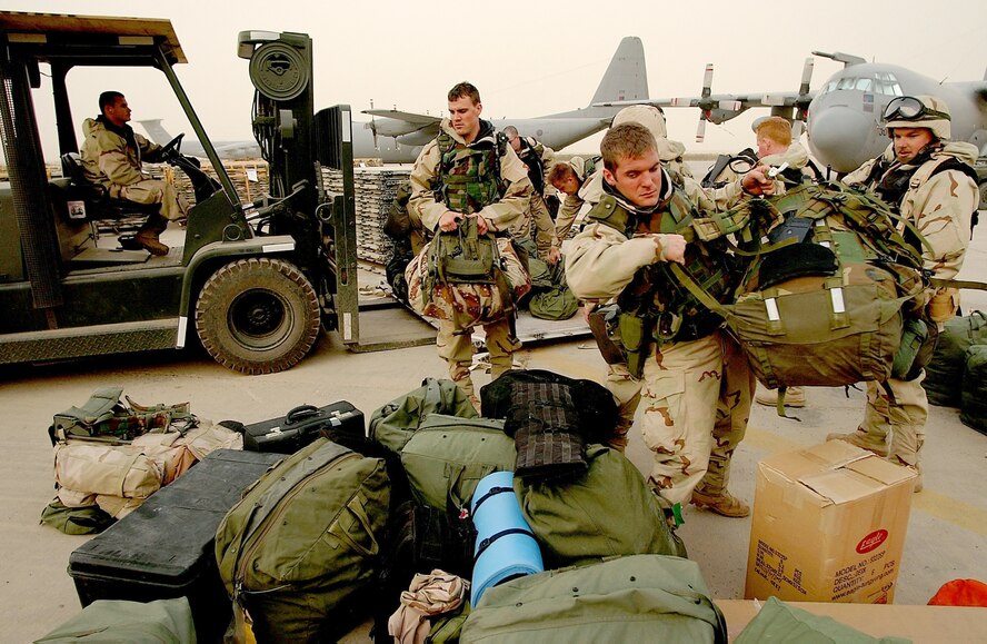 OPERATION IRAQI FREEDOM -- Airmen with the 821st Tanker Airlift Control Element load their personal bags onto a pallet for shipment to a forward-deployed location.  (U.S. Air Force photo by Staff Sgt. Quinton T. Burris)