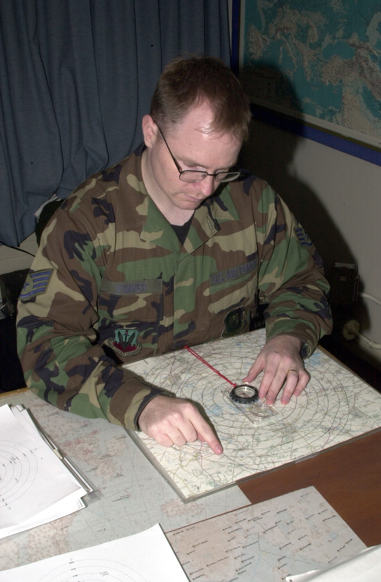 OPERATION IRAQI FREEDOM -- Staff Sgt. Mike Wimmer reads a visibility chart at a forward-deployed location.  Wimmer is weather forecaster assigned to the 457th Air Expeditionary Wing. (U.S. Air Force photo by Tech. Sgt. Jim Fisher)