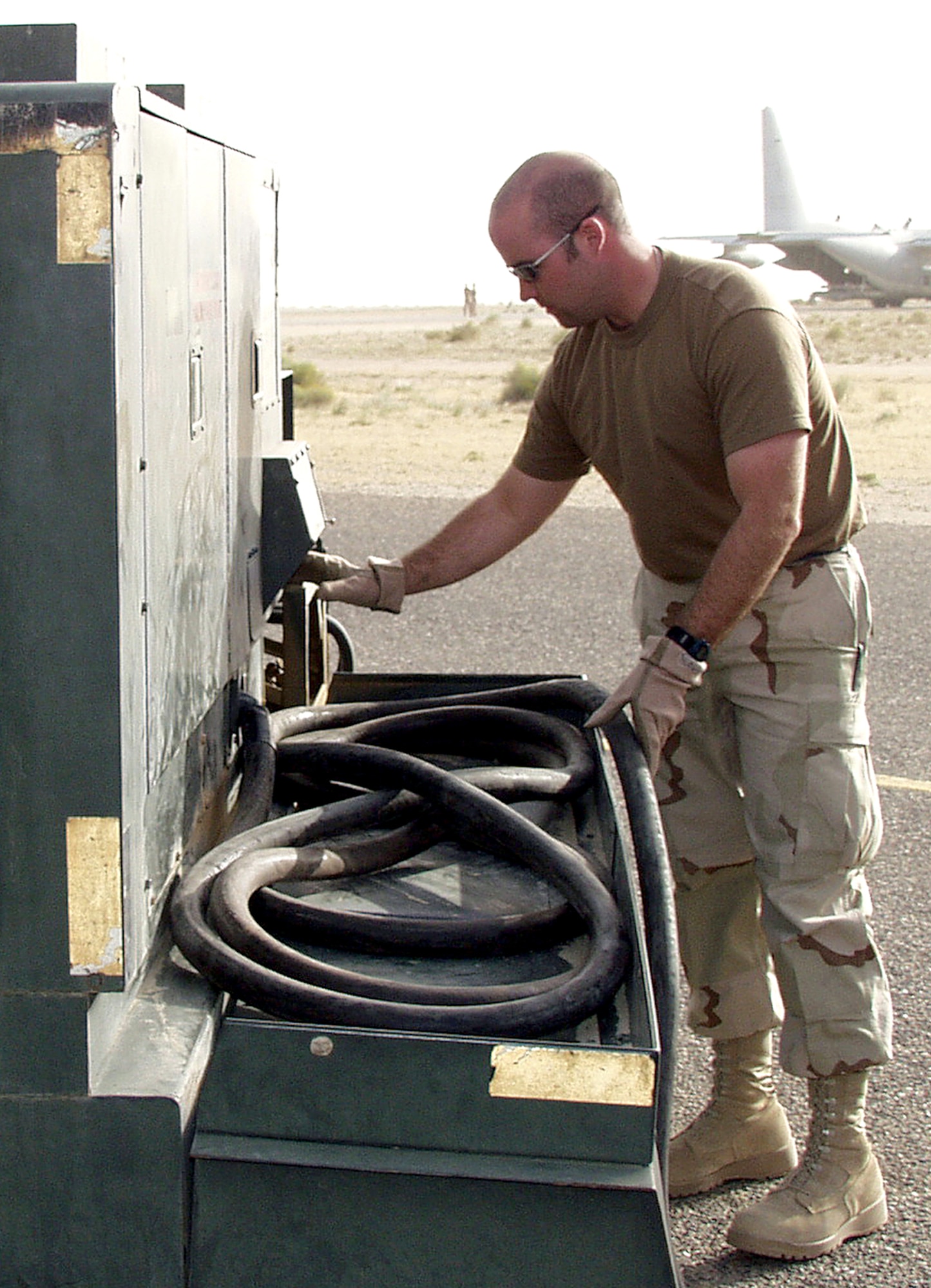 OPERATION IRAQI FREEDOM -- Staff Sgt. Robert Rawlings, a heavy aircraft crew chief with the 386th Air Expeditionary Wing's transient alert team, shuts down an external power unit for a C-130 Hercules heading to Iraq. The transient alert team ensures transient aircraft are properly parked, provides power to aircraft, assists in moving cargo pallets and troubleshoots and fixes maintenance problems. (U.S. Air Force photo by Staff Sgt. Karen J. Tomasik)