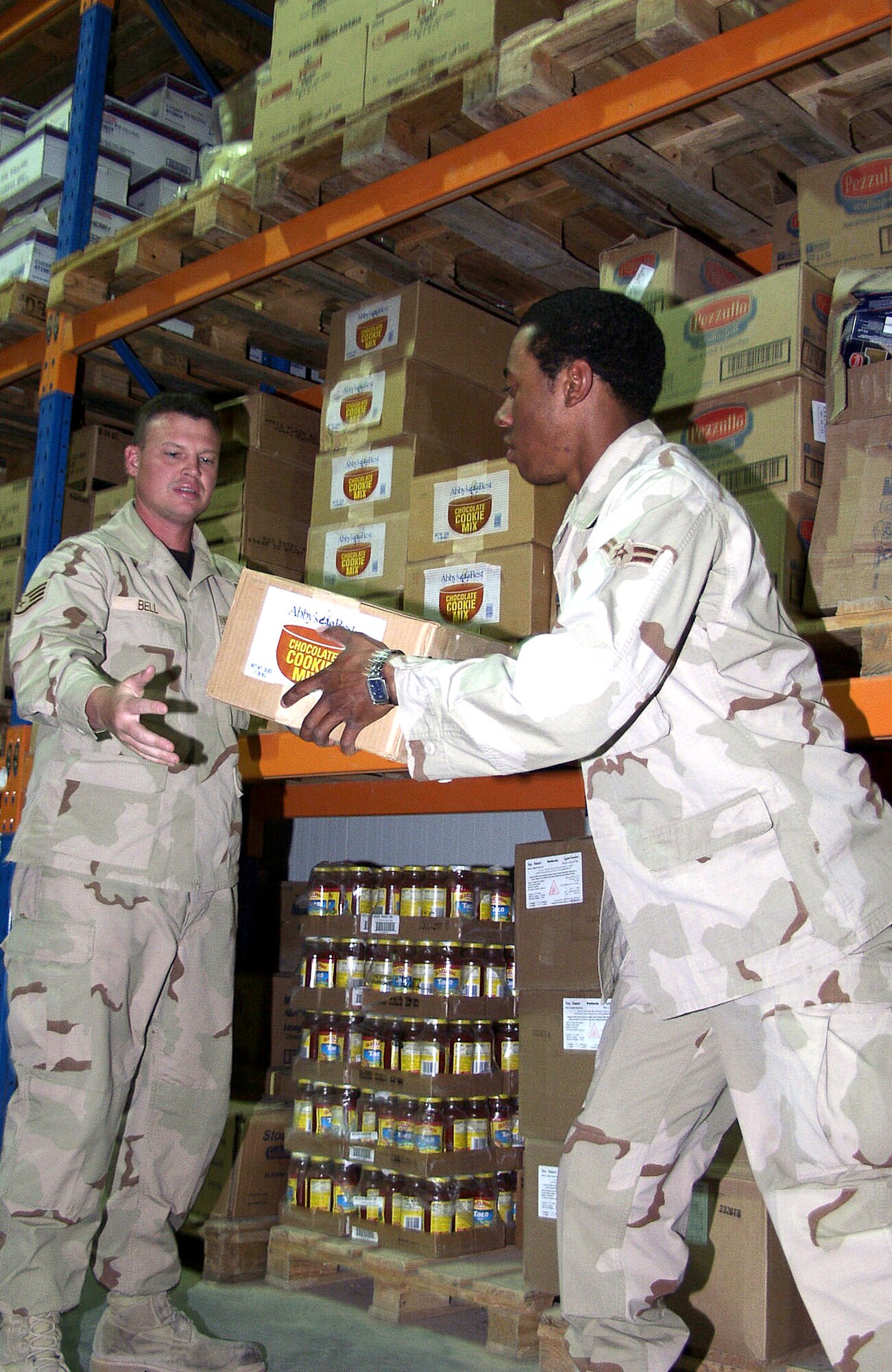 OPERATION IRAQI FREEDOM – Staff Sgt. Steven Bell and Airman 1st Class Idris Royal stock the dry storage warehouse. Approximately $2,500,000 of subsistence is received and prepared monthly in support of the base population. Operation Iraqi Freedom is the multinational coalition effort to liberate the Iraqi people, eliminate Iraq’s weapons of mass destruction and end the regime of Saddam Hussein. (U.S. Air Force photo)