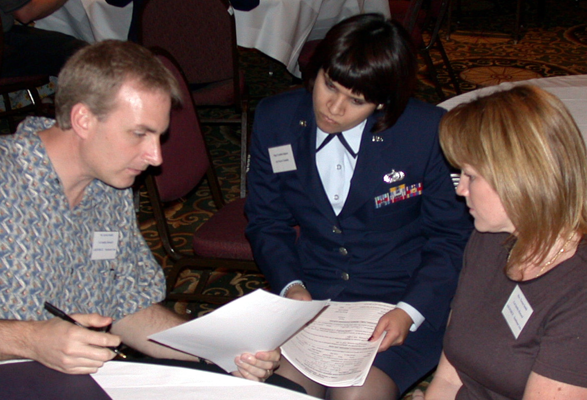 HOUSTON -- Staff Sgt. Cynthia Iniguez from the casualty office at the Air Force Personnel Center at Randolph Air Force Base, Texas, speaks with family members at a recent meeting for families of servicemembers missing from past wars.  More than 150 Texas families met in Houston with military representatives and officials from the Defense POW/Missing Personnel office, the agency responsible for oversight of the recovery process.  (U.S. Air Force photo by 1st Lt. Brandon Lingle) 