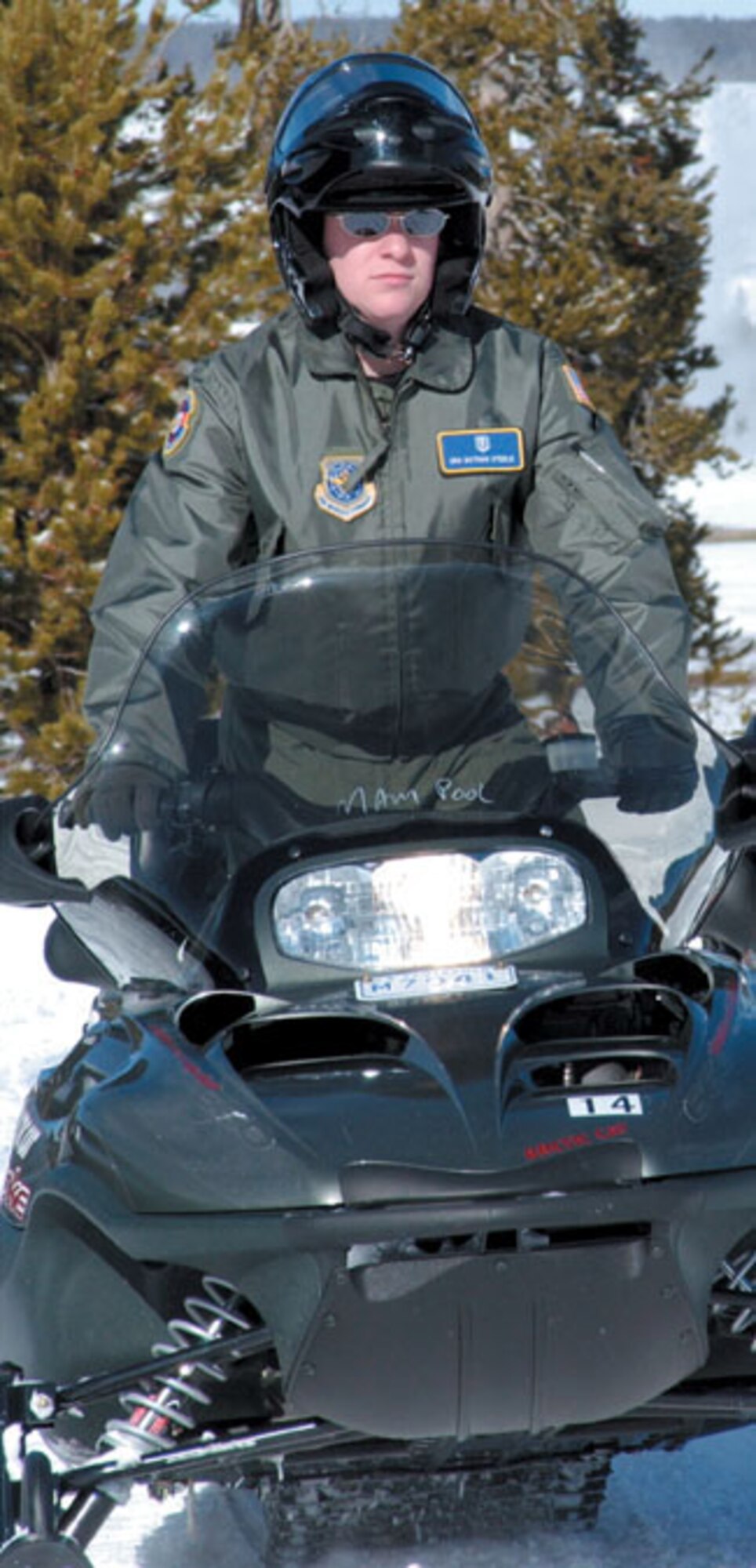 YELLOWSTONE NATIONAL PARK -- Steele rides a snowmobile near Old Faithful during a medical exercise here called Winterops 2003.  During Yellowstone's harsh winter season, snowmobiles are the quickest way for emergency medical technicians to get around the park.  (U.S. Air Force photo by Bo Joyner)