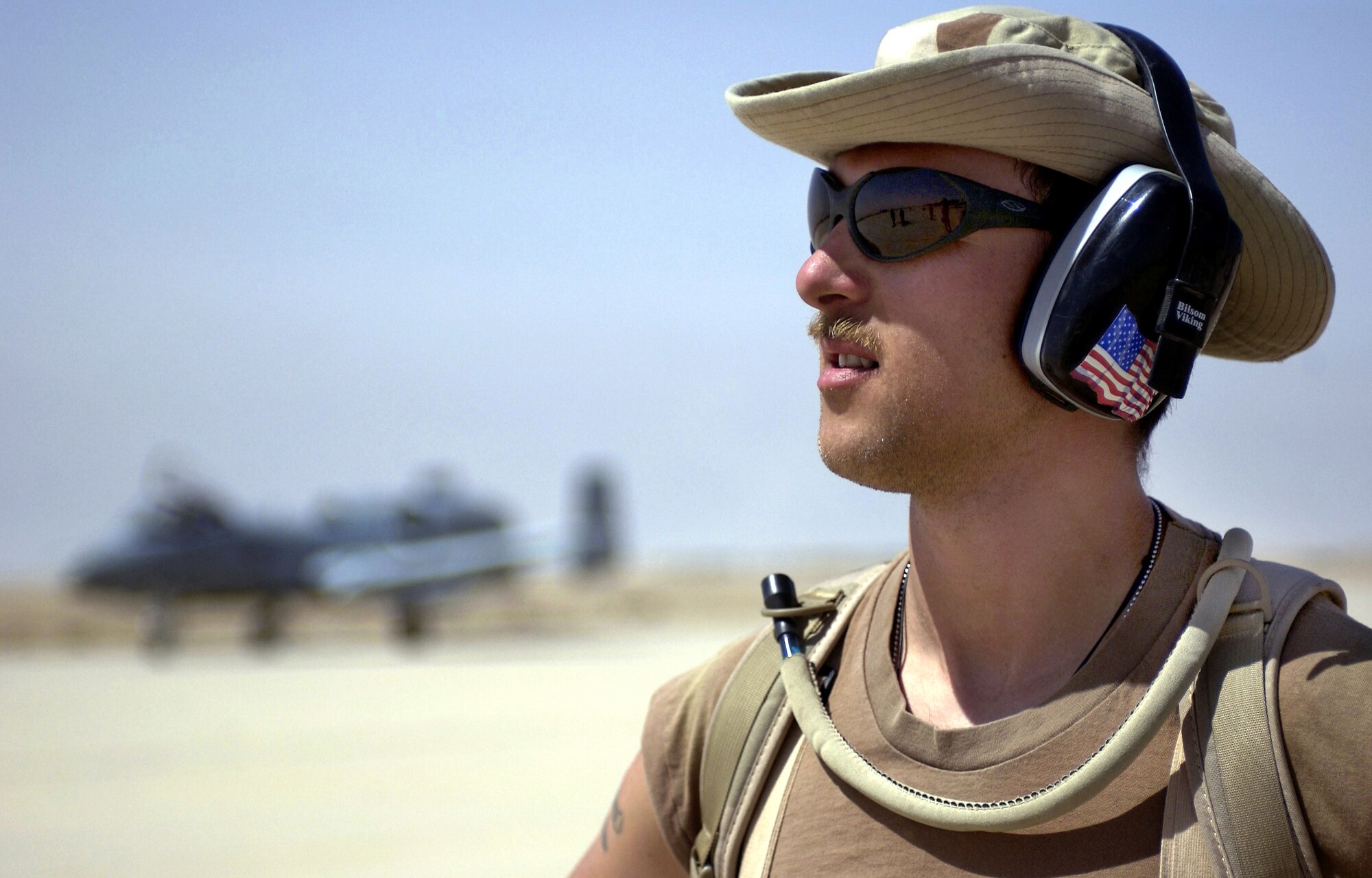 OPERATION IRAQI FREEDOM -- Staff Sgt. James Foster waits for an A-10 Thunderbolt II to taxi to its parking spot April 3 at a forward-deployed location in southern Iraq.  Foster is a weapons loader currently assigned to the 392nd Air Expeditionary Wing.  (U.S. Air Force photo by Staff Sgt. Shane A. Cuomo) 