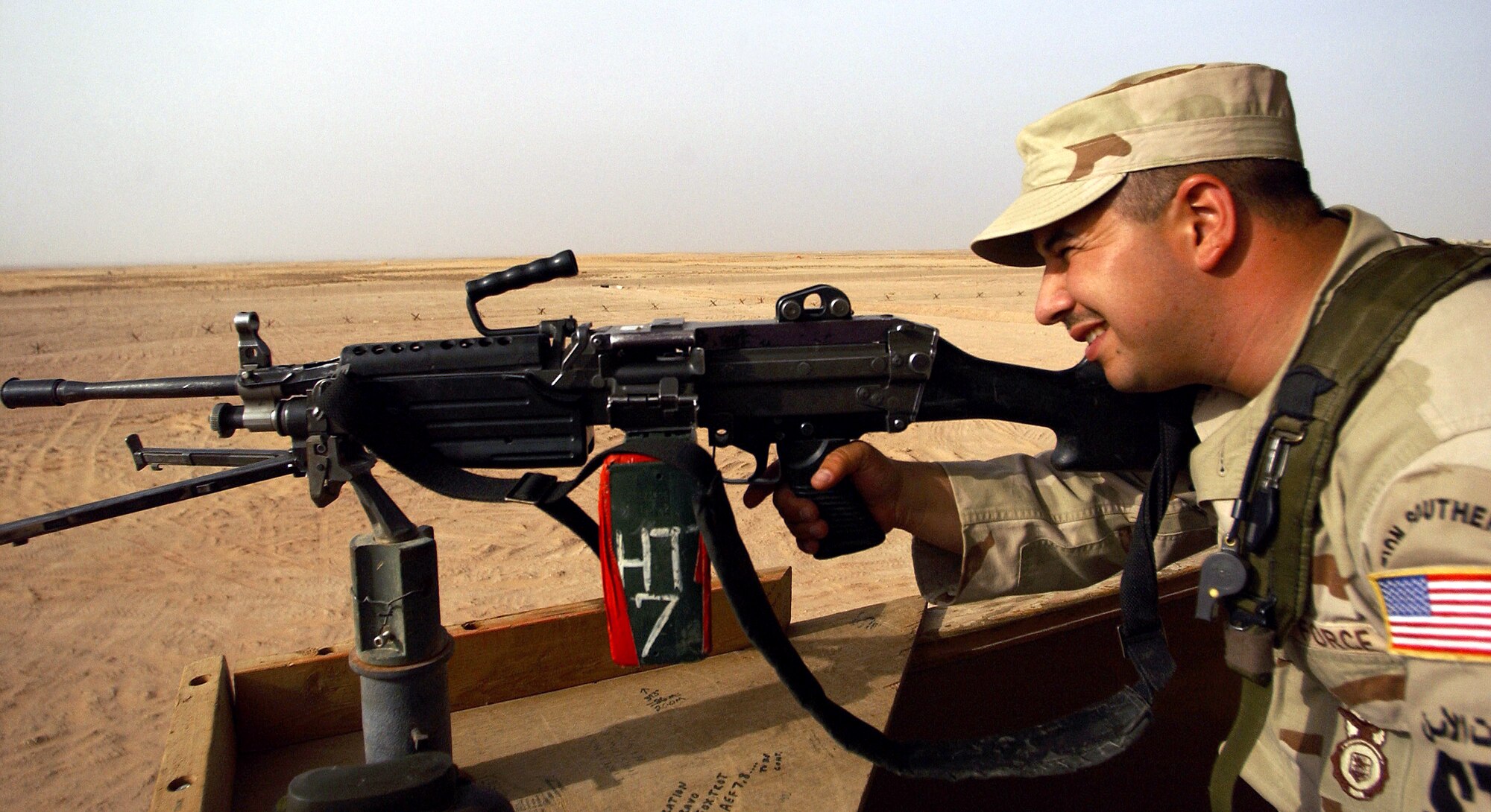 OPERATION IRAQI FREEDOM -- Staff Sgt. Angel Degennaro, a security forces craftsman deployed from the 301st Security Forces Squadron, Carswell Air Reserve Station, Fort Worth, Texas, to the 363rd Expeditionary Security Forces Squadron, sets up an M-249 machine gun prior being relieved by night shift in a guard tower on April 3.  (U.S. Air Force photo by Staff Sgt. Matthew Hannen) 