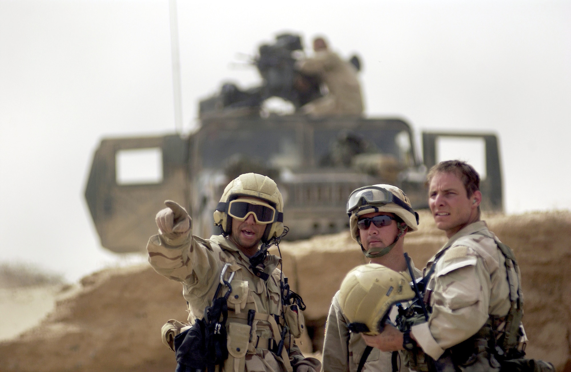 OPERATION IRAQI FREEDOM -- Pararescuemen from the 301st Rescue Squadron talk with a member of the 101st Airborne Division April 6, at a forward deployed location in Iraq during Operation Iraqi Freedom.  Operation Iraqi Freedom is multi-national coalition effort to liberate the Iraqi people, eliminate Iraq's weapons of mass destruction and bring an end to the regime of Saddam Hussein. (U.S. Air Force photo by Staff Sgt. Shane A. Cuomo) 

