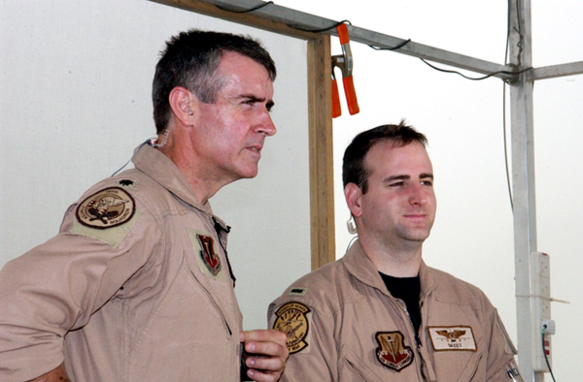OPERATION IRAQI FREEDOM -- Lt. Col. Mike Webb and 1st Lt. Chad Martin, 332nd Air Expeditionary Wing fighter pilots, answer questions to stateside reporters during a live satellite feed from Kuwait City. (U.S. Air Force Photo by Master Sgt. Stefan Alford)