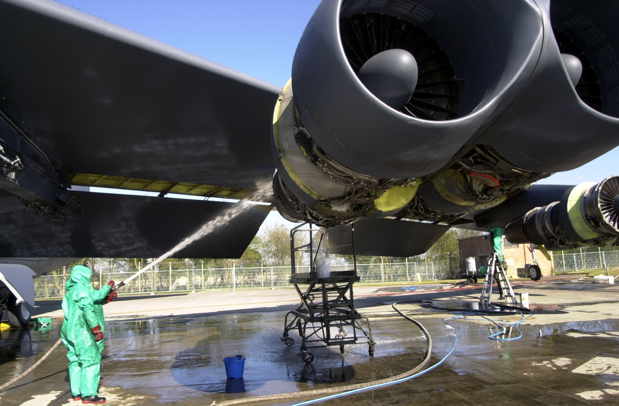 OPERATION IRAQI FREEDOM -- deployed to a forward location  perform a "wash" on a B-52 Stratofortress.  The planes are washed routinely every 120 days to prevent corrosion.  The base at which these troops are deployed is currently home of the 457th Air Expeditionary Group which has been positioned to support Operation Iraqi Freedom.  The operation is the multinational coalition effort to liberate the Iraqi people, eliminate Iraq's weapons of mass destruction and end the regime of Saddam Hussein. (U.S. Air Force photo by Airman 1st Class Stacia M. Willis)  