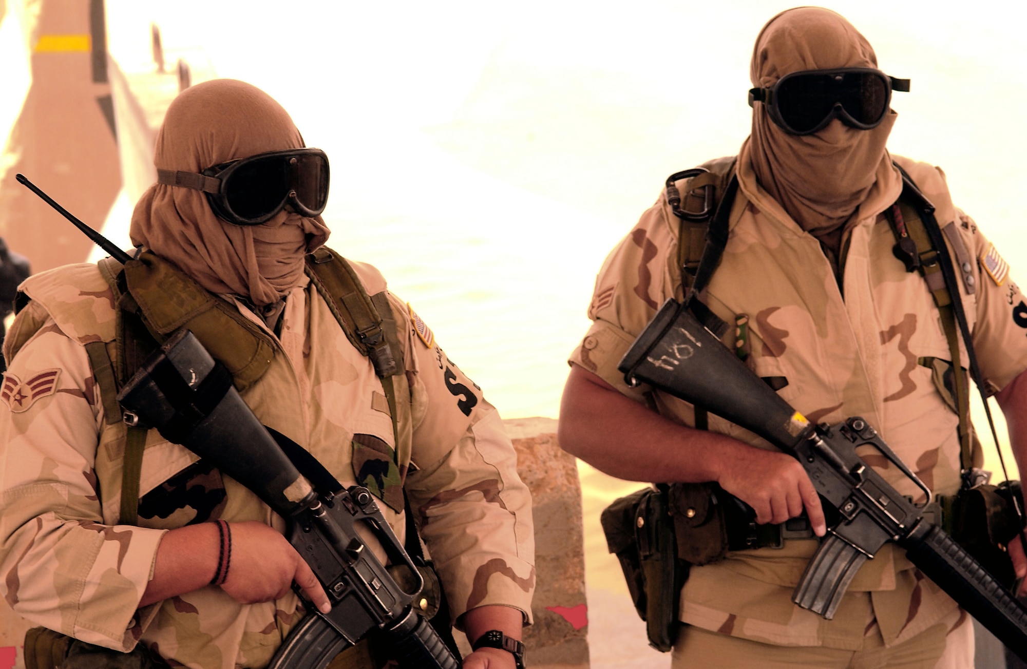 OPERATION IRAQI FREEDOM -- Senior Airman Greg Pelletier and Senior Airman Phil Soares, both security forces journeyman deployed from the 157th Security Forces Squadron, Pease Air National Guard Station, N.H., to the 363rd Expeditionary Security Forces Squadron, authorize a vehicle to proceed through an entry control point during a sand storm on April 7. (U.S. Air Force photo by Staff Sgt. Matthew Hannen) 