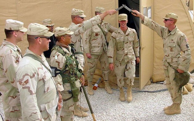 OPERATION IRAQI FREEDOM -- Senior Airman James Evans walks out the door and into a security forces guide-on following his marriage by proxy ceremony.  Evans is a security forces airman currently deployed with the 444th Air Expeditionary Group.  (U.S. Air Force photo by Master Sgt. Charles Ramey)