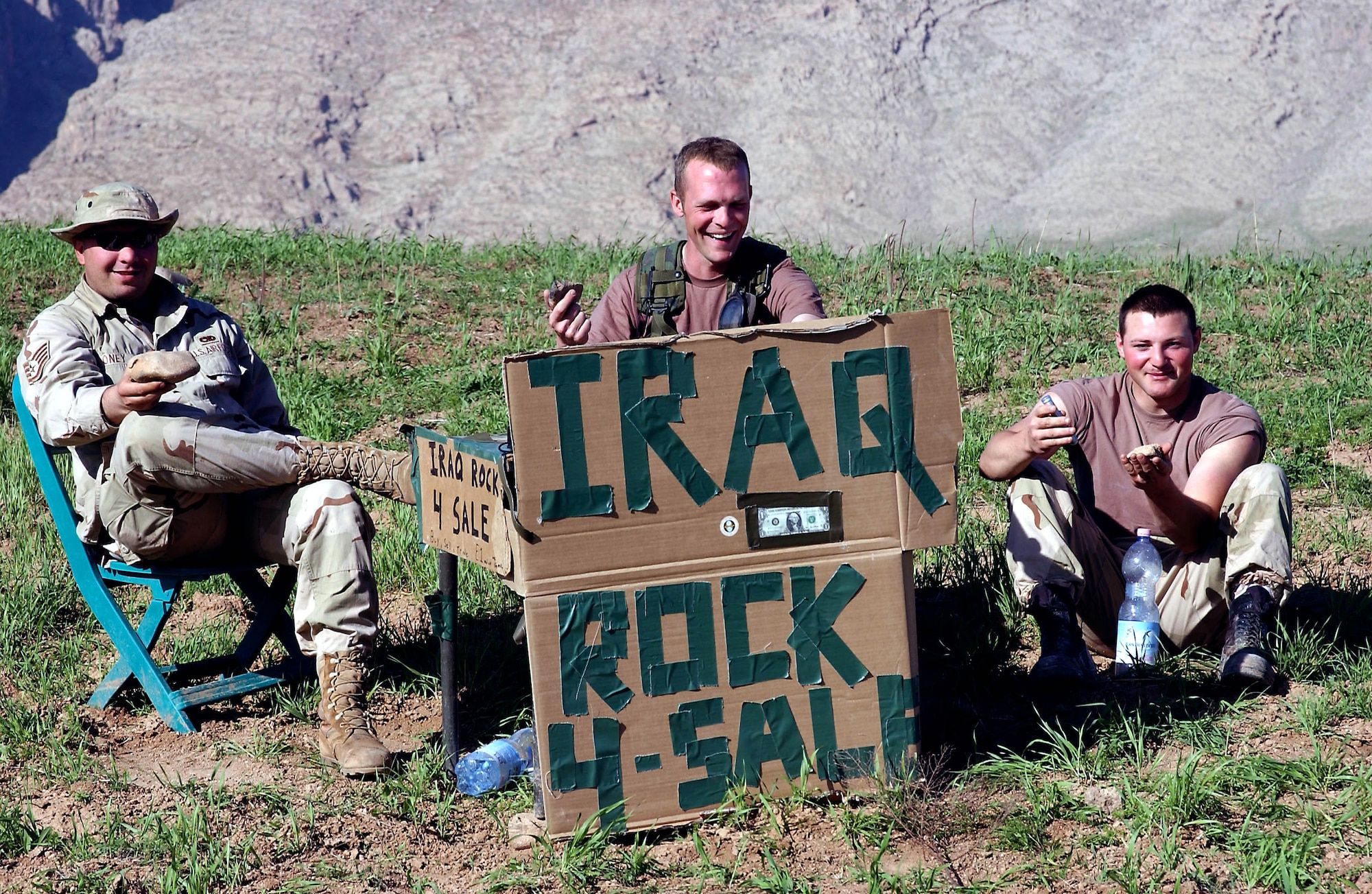 OPERATION IRAQI FREEDOM -- The rock merchants at Bashur Airfield in northern Iraq are (left to right) Staff Sgts. Cliff Oney, Todd Jackson and Senior Airman Luke Novak.  They started "selling" rocks to passing aircrews as a way to let off steam from their jobs on the flightline.  (U.S. Air Force photo by Master Sgt. Keith Reed)