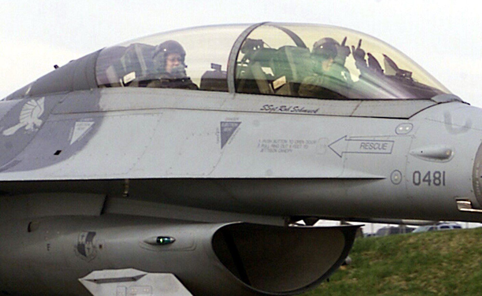 SPANGDAHLEM AIR BASE, Germany -- Capt. Jessica Rhyne, 23rd Fighter Squadron pilot, makes the “big guns” gesture as she and 1st Lt. Corinne Gilliam, 23rd FS Intelligence Flight officer, prepare for flight April 1. The captain and 1st Lt. Gilliam were part of a three-“man” flying training mission, which included Spangdahlem Air Base’s only other female F-16 pilot, 1st Lt. Leigh Noel, 22nd Fighter Squadron.  (U.S. Air Force photo by Staff Sgt. Karen Z. Silcott)