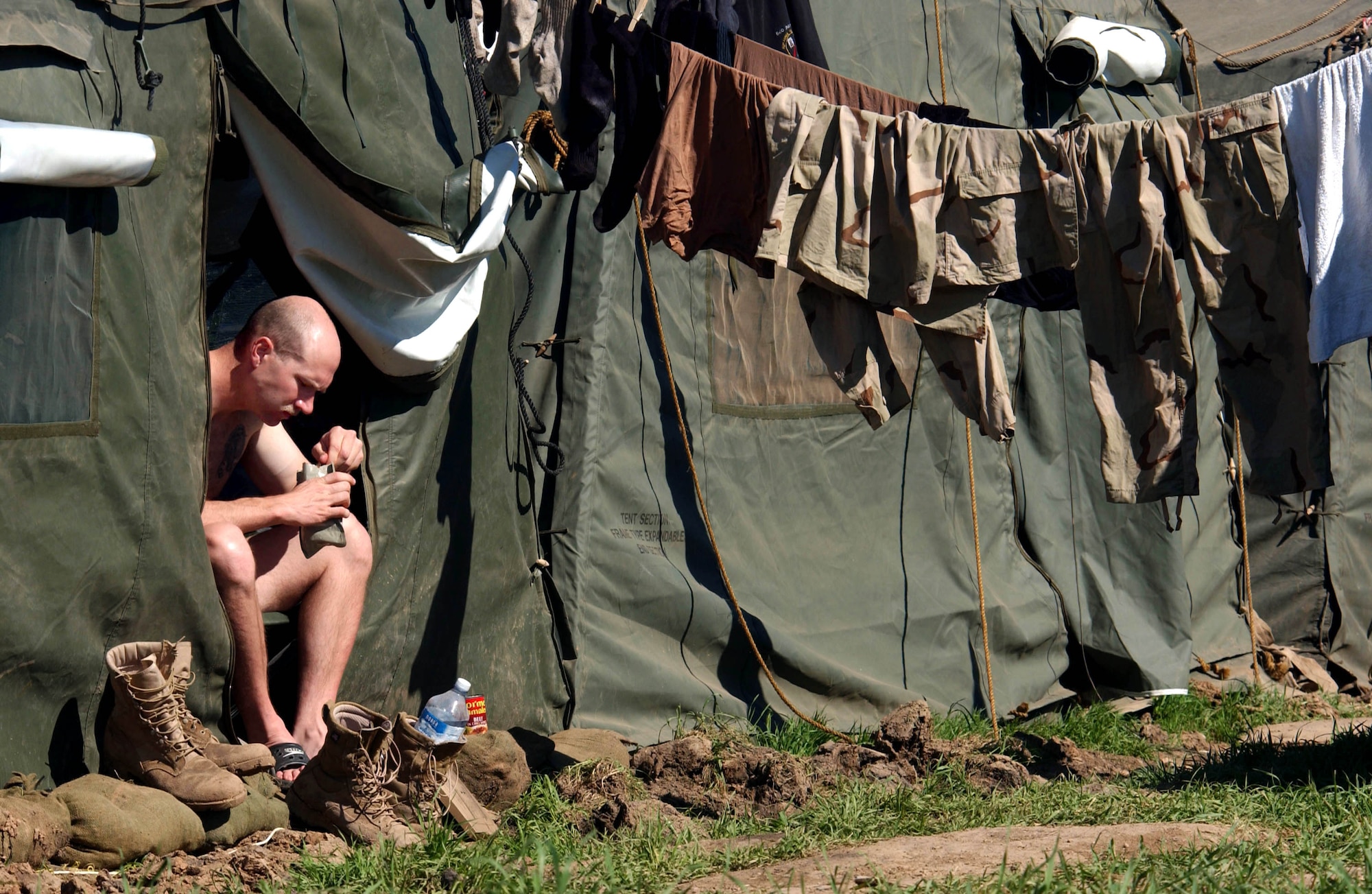 OPERATION IRAQI FREEDOM -- Security Forces member Tech. Sgt. Bobby Hoyt takes a minute to grab lunch, a meals ready to eat at the entrance to his tent.  Hoyt is deployed with the 86th Expeditionary Contingency Response Group at Bashur Airfield in northern Iraq.  (U.S. Air Force photo by Master Sgt. Keith Reed)