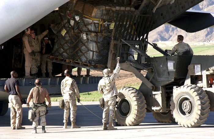 OPERATION IRAQI FREEDOM -- Members of the 86th Air Mobility Squadron rush in to offload a C-17 Globemaster III at Bashur Air Base, Iraq.  The airmen are offloading aircraft in record time and, as of April 14, had offloaded more than 220 aircraft with more than 13 million pound of cargo.  The heavy aircraft loads have caused the base runway to crack.  (U.S. Air Force photo by Master Sgt. Keith Reed)