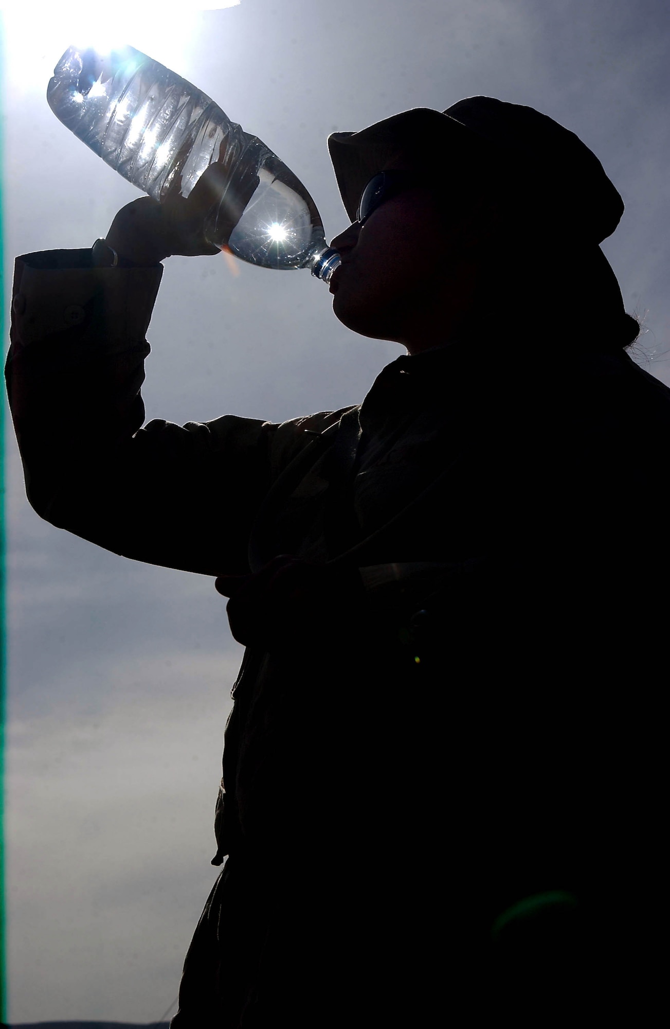 OPERATION IRAQI FREEDOM -- Staff Sgt. Sabrina Hauser takes a long drink of bottled water at Bashur Airfield in northern Iraq.  Drinking bottled water keeps the risk of disease down.  Hauser is a videographer with the 1st Combat Camera Squadron at Charleston Air Force Base, S.C.  (U.S. Air Force photo by Master Sgt. Keith Reed)