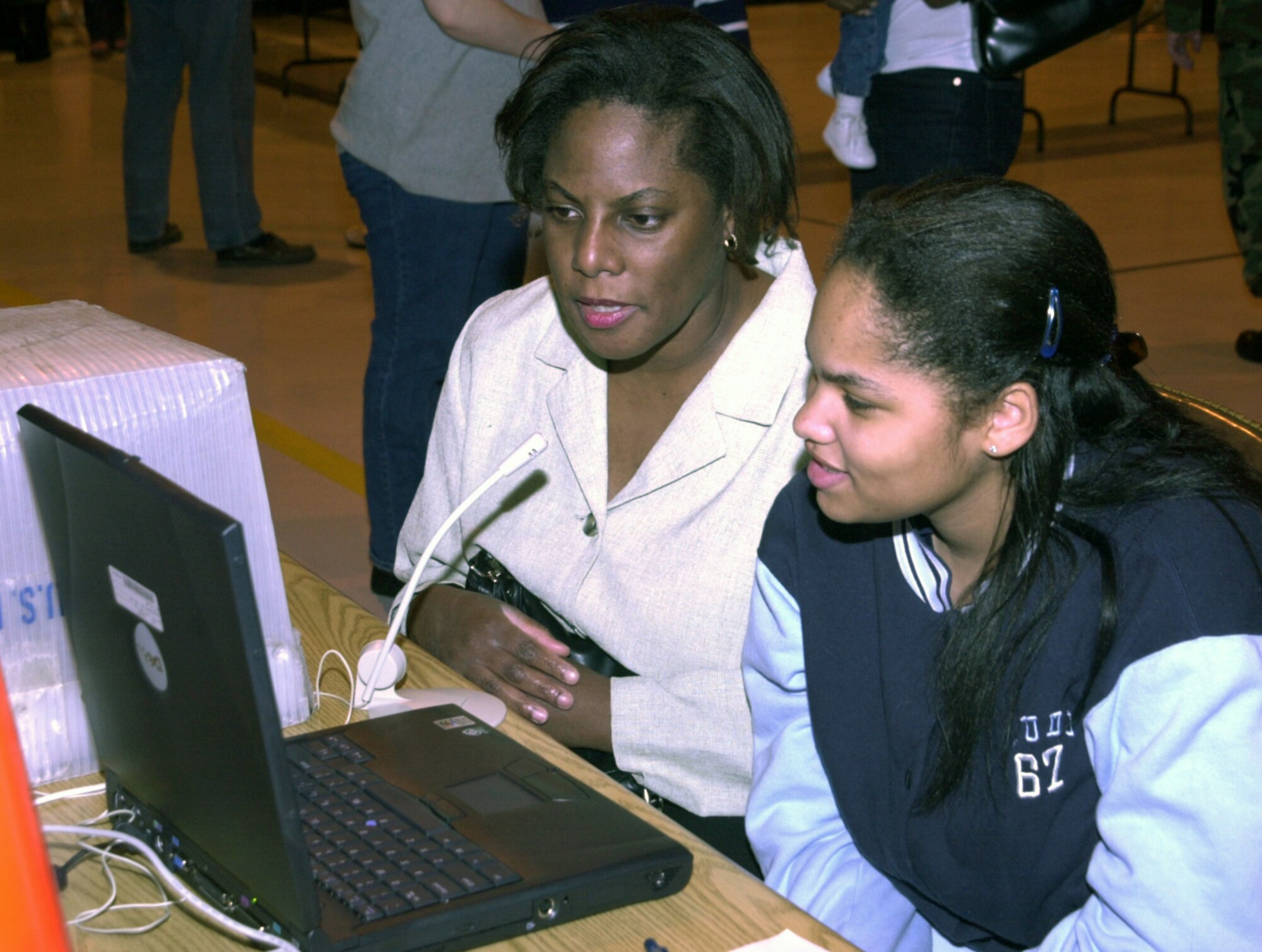 ANDREWS AIR FORCE BASE, Md. -- Deborah Matos-Lowe and her daughter, Mercedes Matos, age 13, send a video e-mail to Master Sgt. Russell Lowe, 113th Logistics Squadron, D.C. Air National Guard.  Lowe and other members of the squadron have been deployed for nearly two months. Families of the D.C. ANG gathered April 12 at Andrews Air Force Base, Md., for a pot-luck dinner, children’s games and a chance to help relieve some of the stress associated with the deployment of a loved one. (U.S. Air Force photo by Staff Sgt. A.J. Bosker)