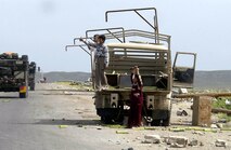 OPERATION IRAQI FREEDOM -- Outside Kirkus, Iraq, Tech. Sgt. Steve Fausili took a photo of Iraqi boys on a burned out truck waving at an American convoy.  Fausili is a combat cameraman assigned to the 1st Combat Camera Squadron at Charleston Air Force Base, S.C.  (U.S. Air Force photo by Tech. Sgt. Steve Fausili)