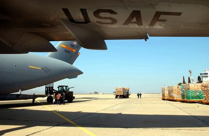 OPERATION IRAQI FREEDOM -- Airmen from the 409th Air Expeditionary Group, deployed to Camp Sarafovo, Bulgaria, palletize and load humanitarian cargo onto a C-17 Globemaster III.  The C-17 landed a Burgas Airport on its way to deliver humanitarian aid to the people of Iraq.  KC-10 Extenders from the 305th/514th Air Mobility Wing, McGuire AFB, N.J., are deployed to Burgas Airport and nearby Camp Sarafovo, Bulgaria, to support tanker operations.  Camp Sarafovo is home to the 409th Air Expeditionary Group, which is currently conducting air refueling operations with KC-10 Extender aircraft that have deployed to Burgas Airport while support operations are conducted from nearby Camp Sarafovo.  Members from various Air Force units world-wide are currently deployed with the 409th AEG in support of Operation Iraqi Freedom.  (U. S. Air Force photo by Master Sgt. Dave Ahlschwede) 