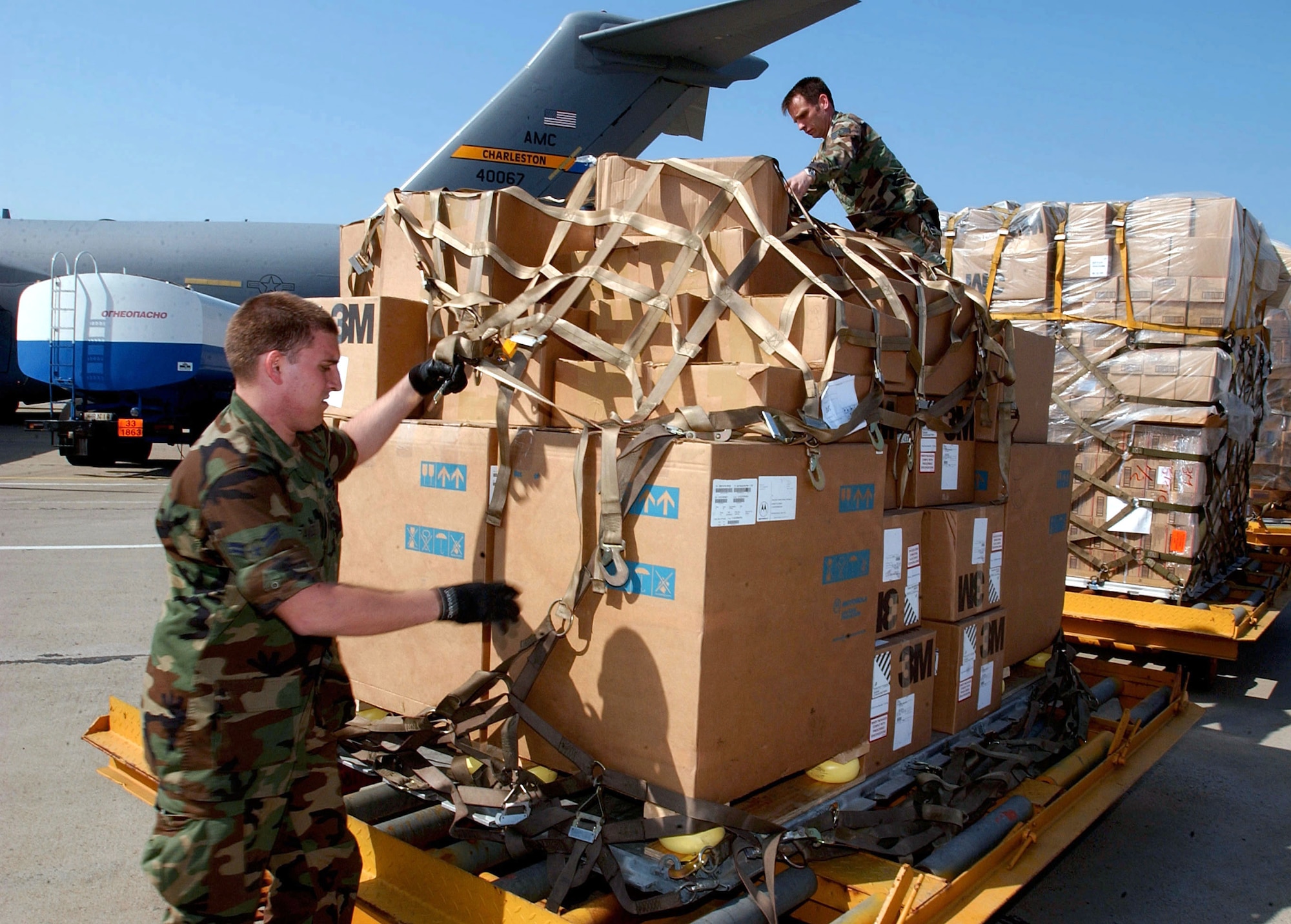 OPERATION IRAQI FREEDOM -- Airmen deployed to Camp Sarafovo, Bulgaria, load humanitarian cargo onto pallets April 15.  The cargo will be loaded onto a C-17 Globemaster III and delivered to the people of Iraq.  They airmen are assigned to the 409th Air Expeditionary Group supporting Operation Iraqi Freedom.  (U.S. Air Force photo by Master Sgt. Dave Ahlschwede)