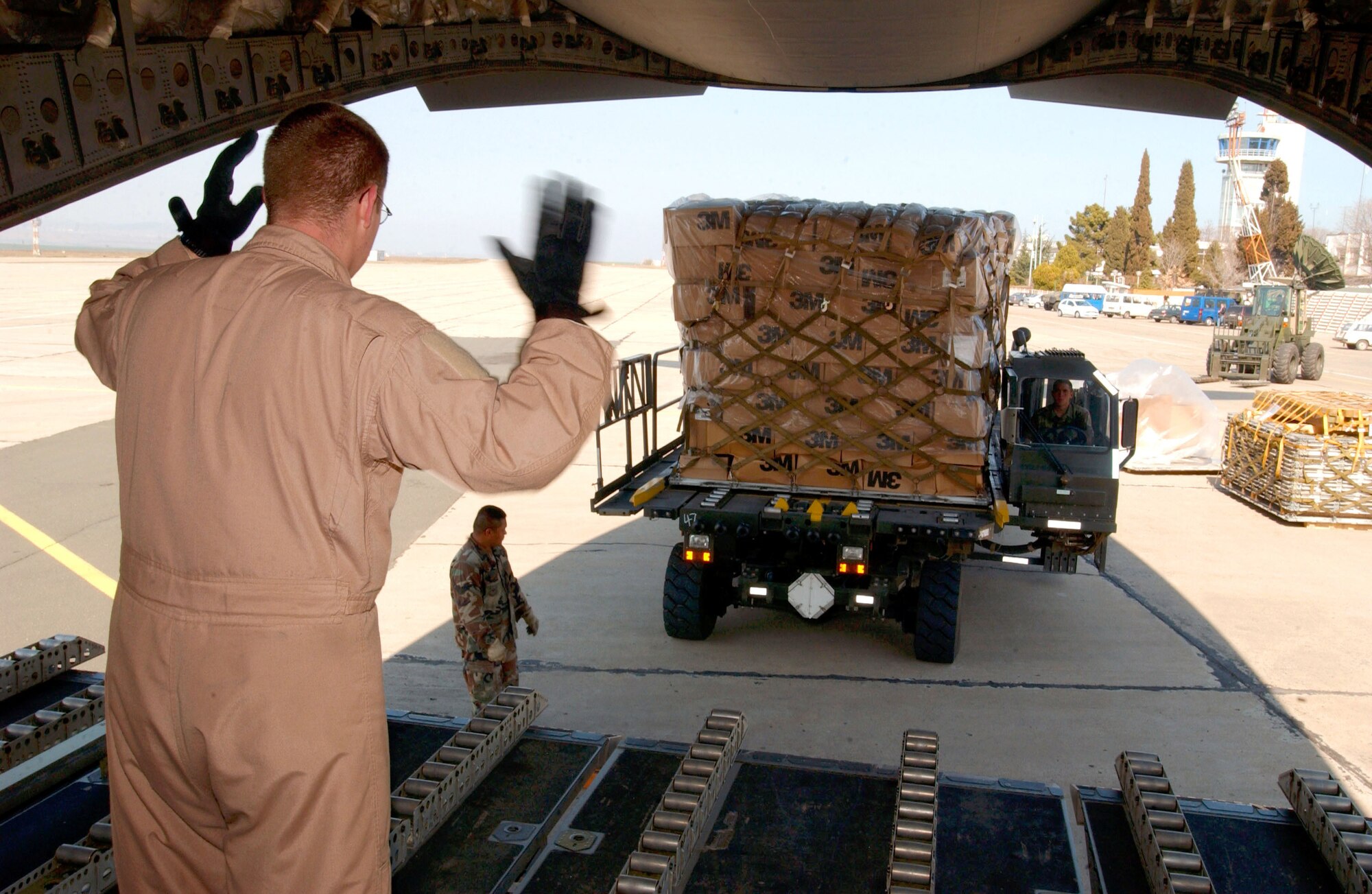 OPERATION IRAQI FREEDOM -- A crewmember guides a pallet of cargo onto a C-17 Globemaster III.  The aircraft landed a Burgas Airport on its way to deliver humanitarian aid to the people of Iraq.  (U.S. Air Force photo by Master Sgt. Dave Ahlschwede)