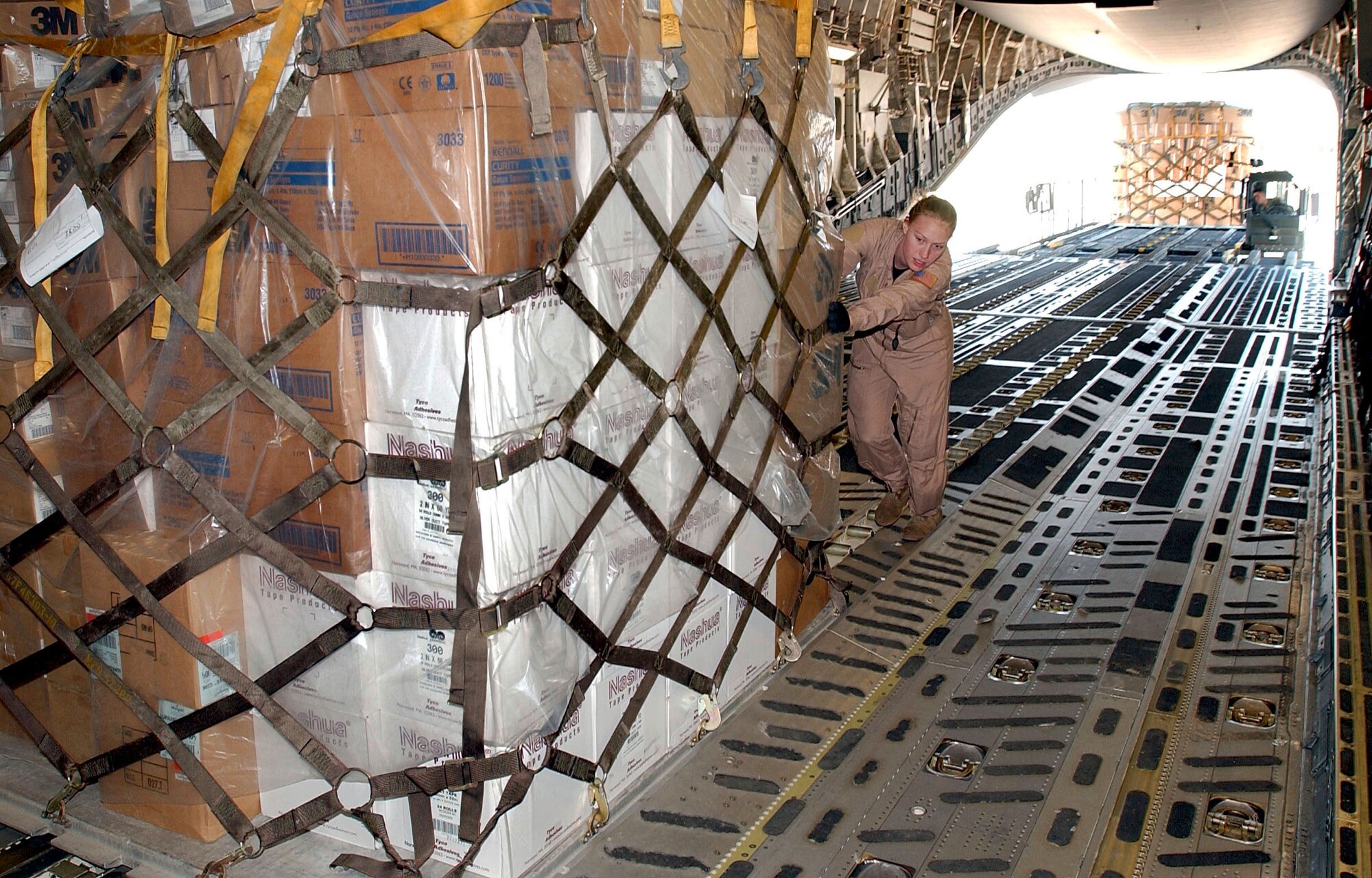 OPERATION IRAQI FREEDOM -- A crewmember pushes a pallet of cargo onto a C-17 Globemaster III.  The C-17 landed a Burgas Airport on its way to deliver humanitarian aid to the people of Iraq.  (U.S. Air Force photo by Master Sgt. Dave Ahlschwede)