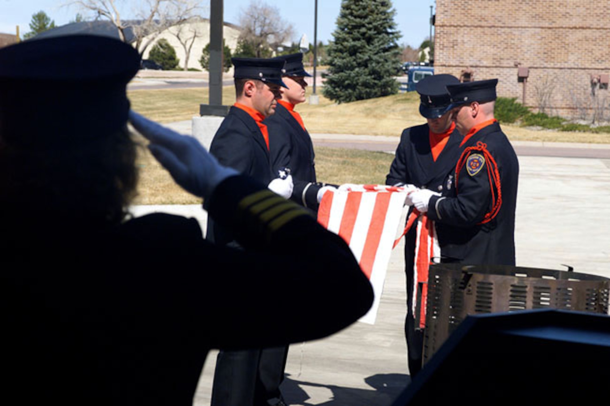 PETERSON AIR FORCE BASE, Colo. -- The 21st Civil Engineer Squadron's fire protection flight here burned 50 U.S. flags recently.  The flight's color guard conducted its first ceremony to give unserviceable U.S. flags a proper disposal.  The ceremony was such a success that the flight has decided to conduct them quarterly.  (U.S. Air Force photo by Dennis Plummer)