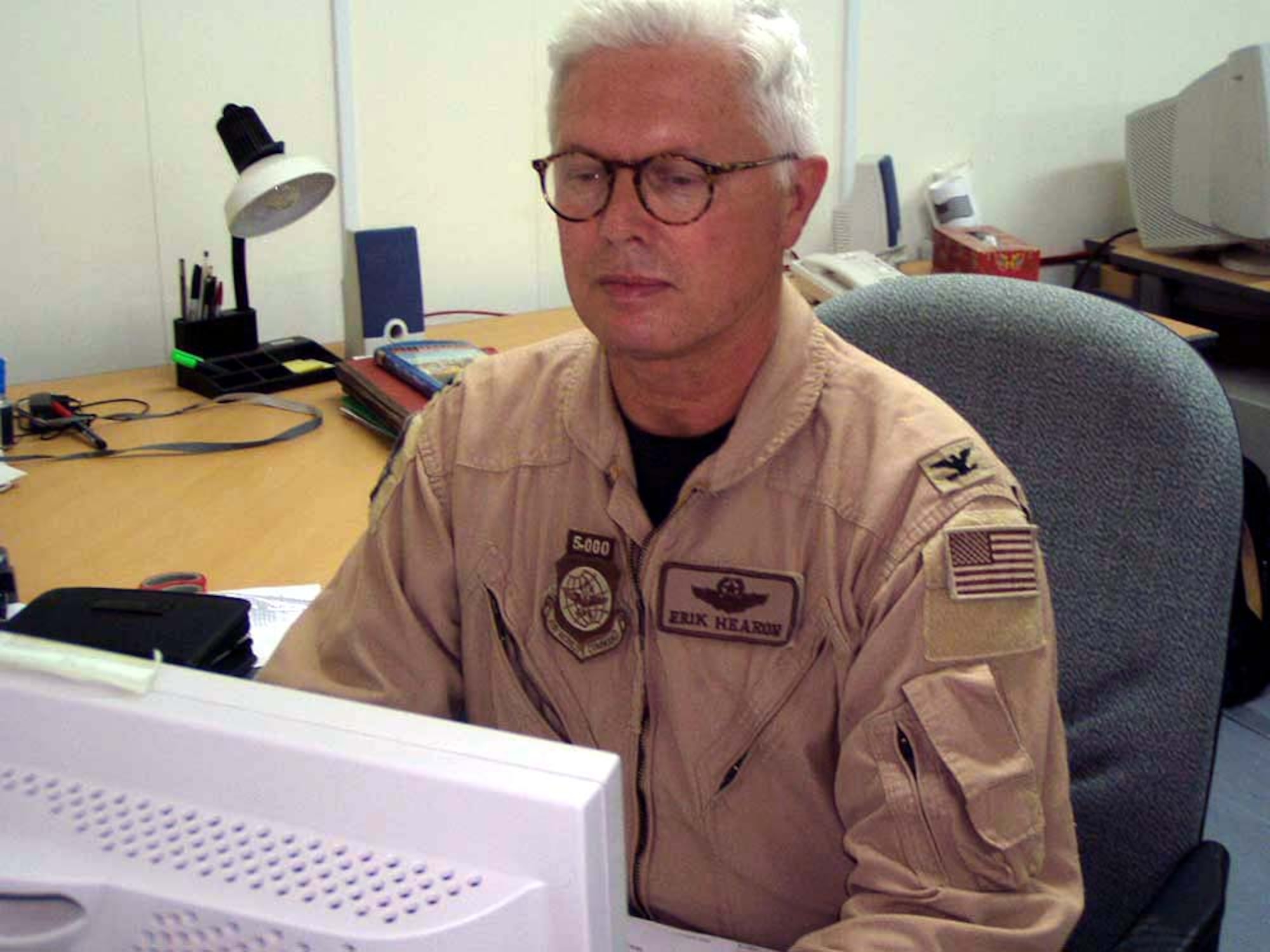 OPERATION IRAQI FREEDOM -- Col. Erik Hearon works at his computer at a forward-deployed location supporting Operation Iraqi Freedom.  He was recently selected by the Department of Defense Marrow Donor Program to donate bone marrow to a leukemia patient.  Hearon directs the regional air movement and control center here.  (U.S. Air Force photo by Tech. Sgt. Dawn M. Harris)