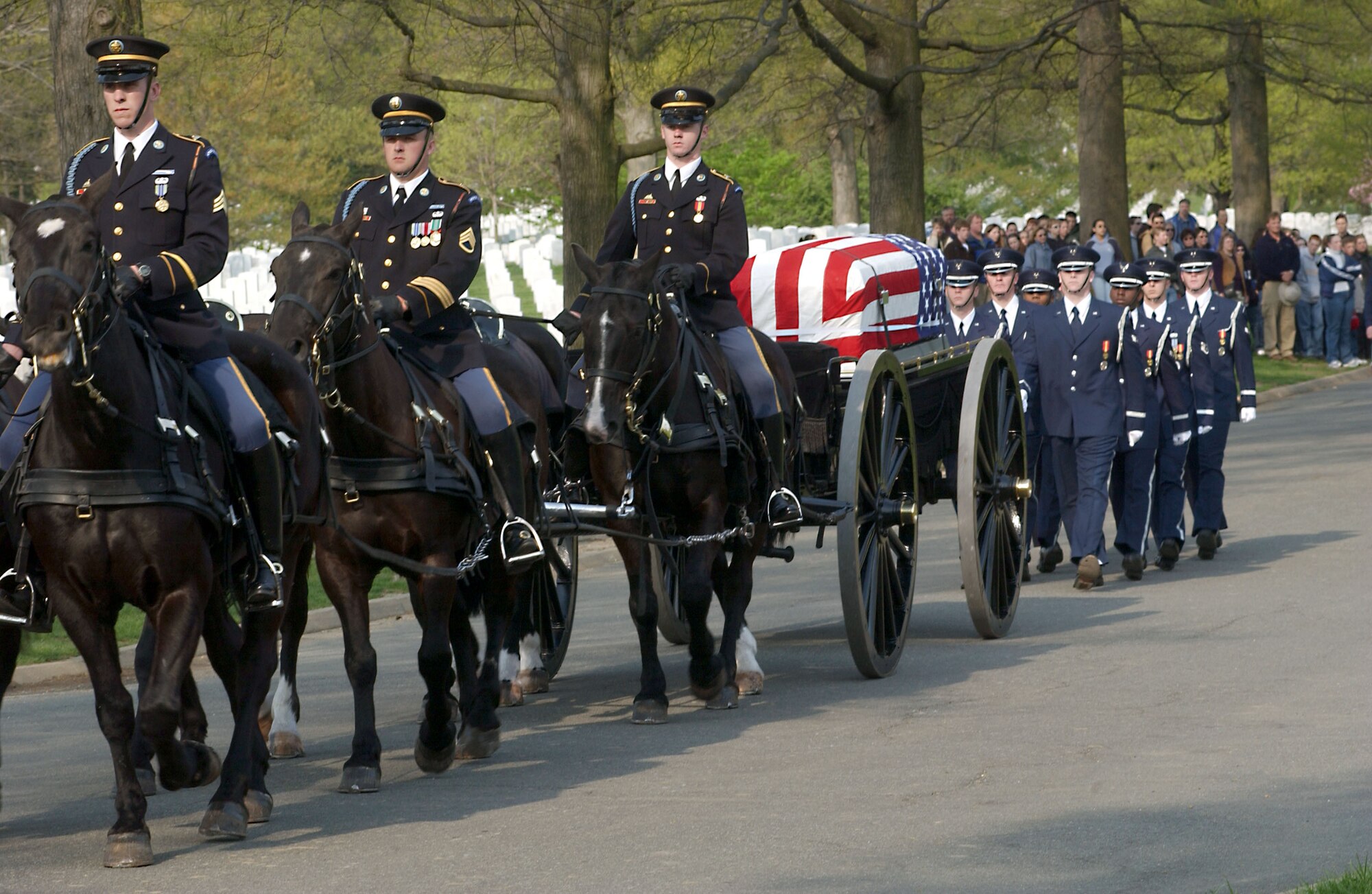 ARLINGTON, Va. (AFPN) -- The U.S. Air Force Honor Guard marches behind the caisson carrying Maj. Gregory L. Stone at Arlington National Cemetery on April 17.   Stone was the first Air Force casualty of Operation Iraqi Freedom.  He was assigned to the Idaho Air National Guard's 124th Wing.  (U.S. Air Force photo by Senior Airman Jera T. Stubblefield)