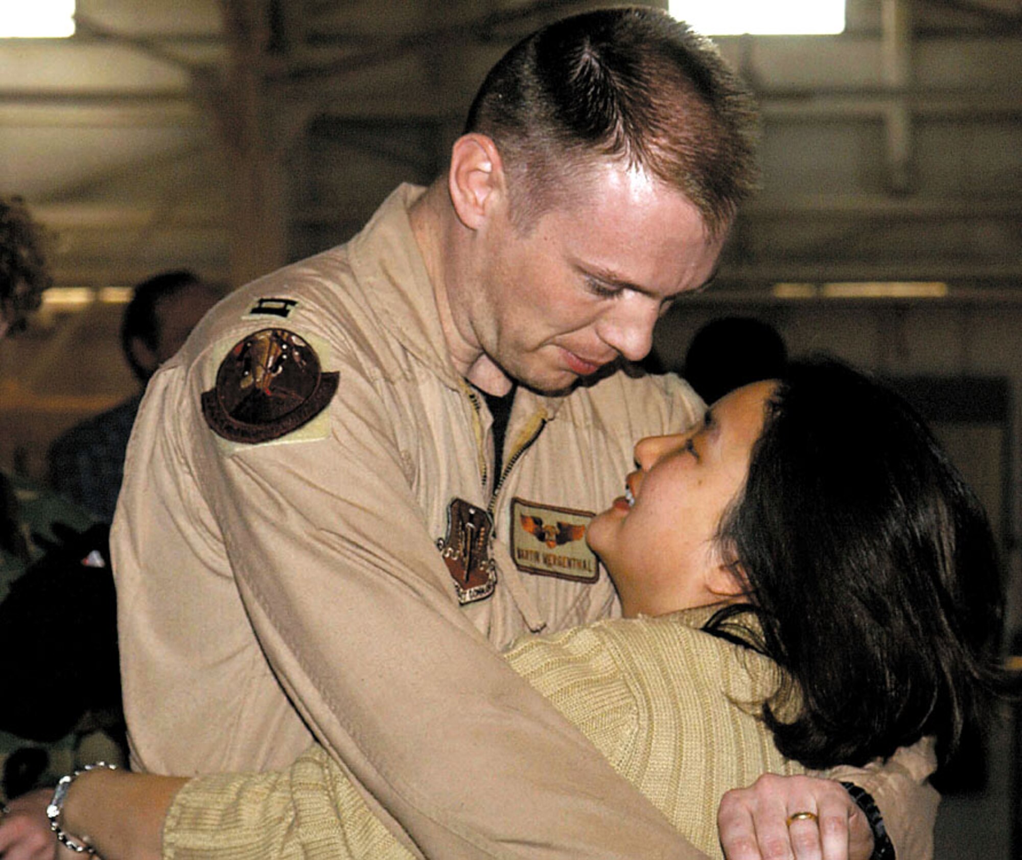 MINOT AIR FORCE BASE, N.D. -- Capt. Martin Mergenthal, a 23rd Bomb Squadron B-52 radar navigator, is welcomed home from serving in Operation Iraqi Freedom by his wife, Kimberly.  (U.S. Air Force photo by Airman Alicia M. Sarkkinen)