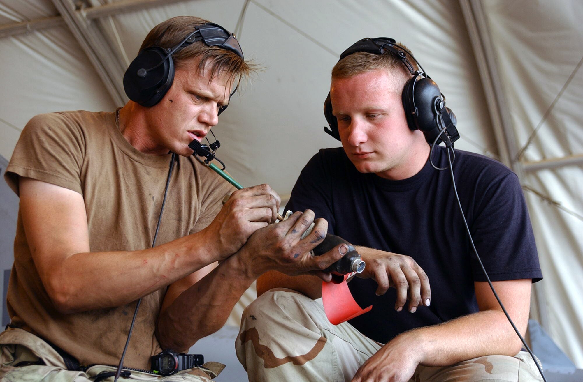 OPERATION IRAQI FREEDOM -- Tech. Sgt. Scott Hooks explains a process to Airman 1st Class Michael Magner during an F-16 fighting Falcon phase inspection.  Both airmen are assigned to the 363rd Expeditionary Aircraft Maintenance Squadron and are deployed from Misawa Air Base, Japan.  (U.S. Air Force photo by Tech. Sgt. Christopher Ball)