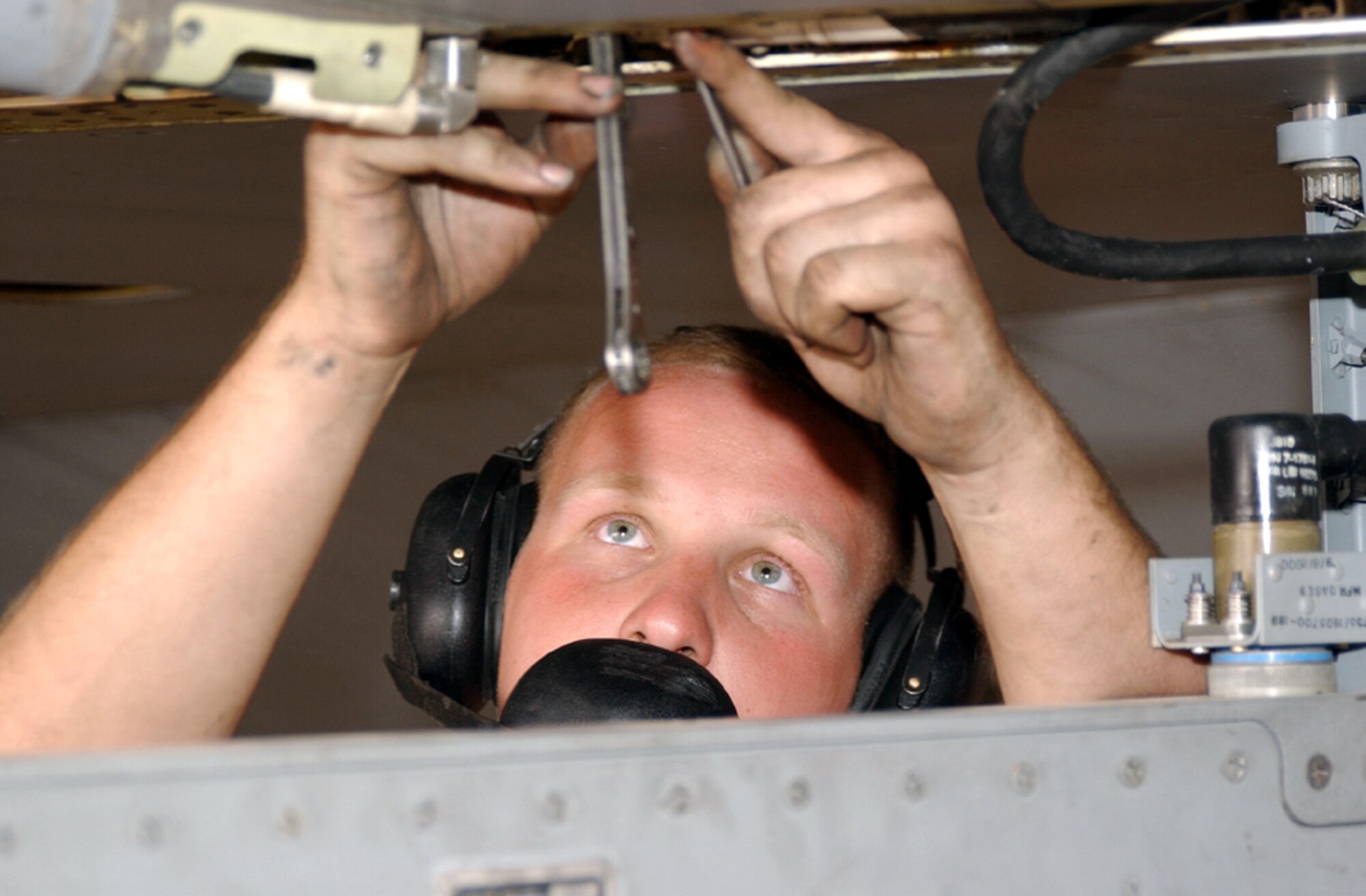 OPERATION IRAQI FREEDOM -- Airman 1st Class Michael Magner adjusts the leading edge flaperon during a rig and operations check on an F-16 Fighting Falcon.  Magner is assigned to the 363rd Expeditionary Aircraft Maintenance Squadron and is deployed from Misawa Air Base, Japan.  (U.S. Air Force photo by Tech. Sgt. Christopher Ball)