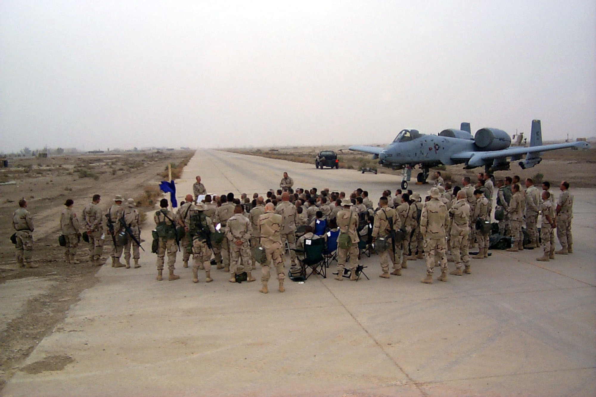OPERATION IRAQI FREEDOM -- About 75 airmen and soldiers gather at Tallil Air Base, Iraq, for an Easter sunrise service on the flightline April 20.  Deployed chaplains offer spiritual and religious services and help increase the morale of warfighters.  (U.S. Air Force photo by Tech. Sgt. Charlie Lespier)