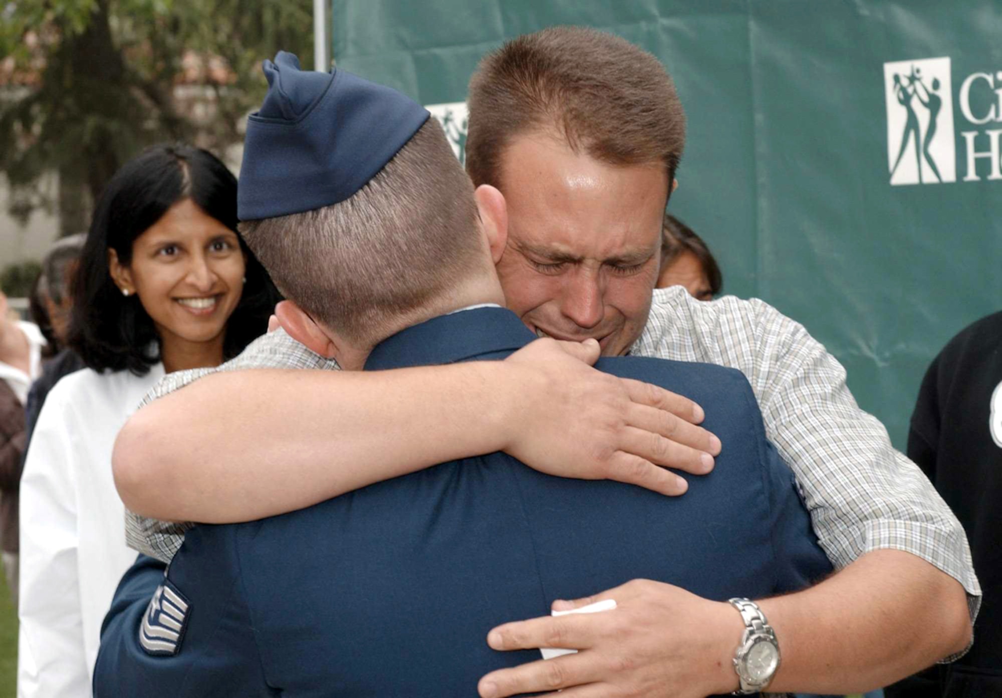 DUARTE, Calif. -- Cancer survivor Gregg Smith hugs Tech. Sgt. Daniel MacDonald, his bone marrow donor.  MacDonald donated bone marrow to Smith on Oct 16, 2001, but only met him recently.  (Courtesy photo by Bob Riha Jr.)