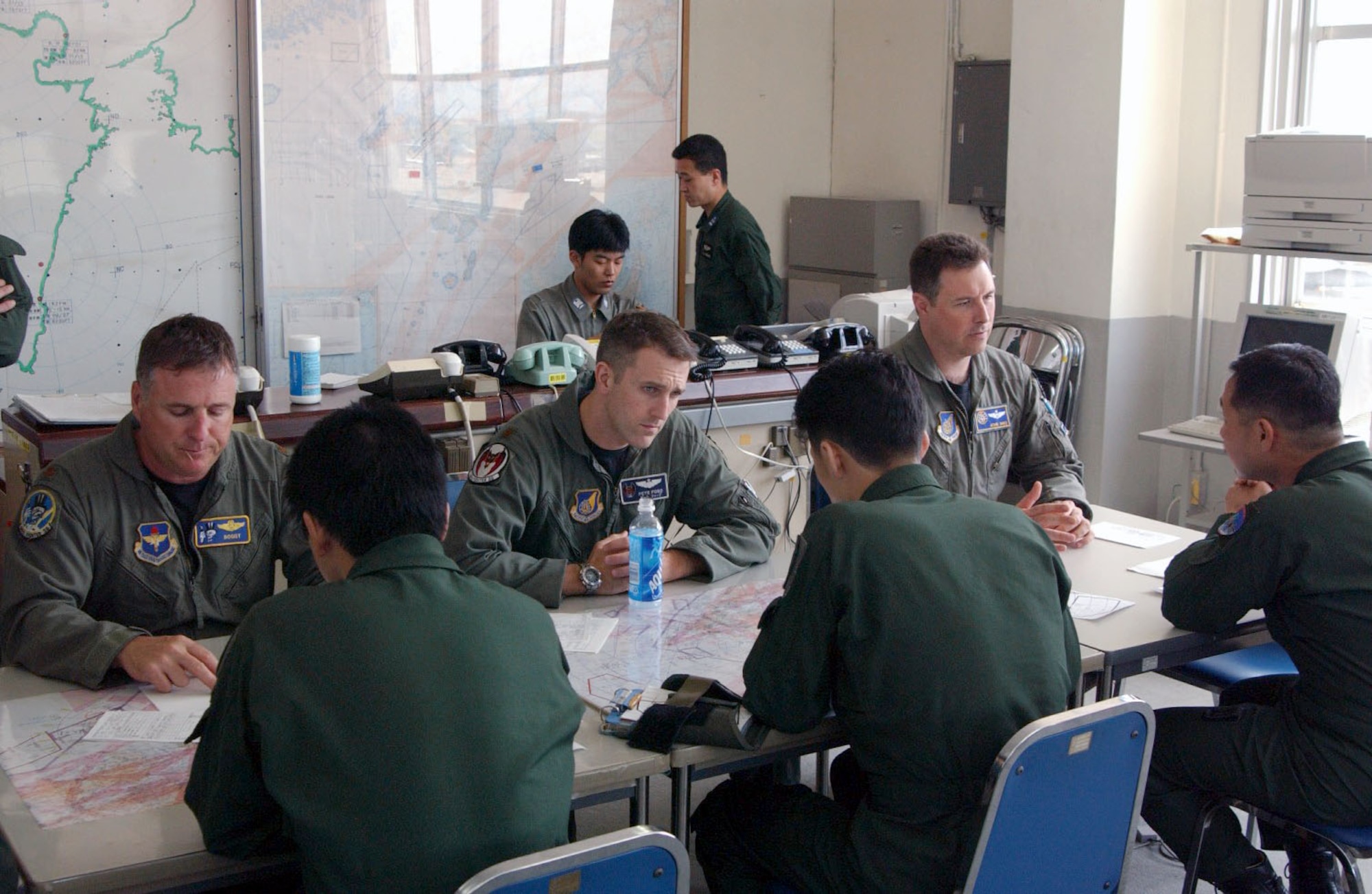 NYUTABARU AIR BASE, Japan -- Instructor pilots from 5th Air Force discuss training tactics and procedures with Japan Air Self-Defense Force F-15 pilots as they prepare to conduct their first air-to-air refueling missions.  This air-refueling skill improves current JASDF capabilities.  (Courtesy photo)
