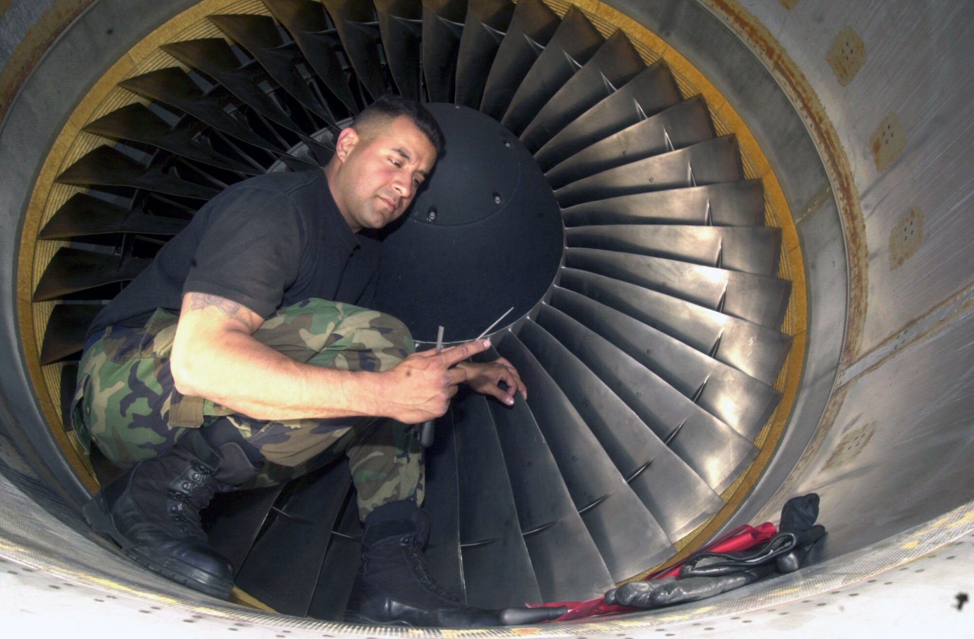 RHEIN-MAIN AIR BASE, Germany -- Staff Sgt. Tony Trevino, 726th Air Mobitlity Squadron jet engine mechanic, blends the blades of a C-17 Globemaster lll engine on the flightline. The 362nd Aerospace Expeditionary Group at Rhein Main set an Air Mobility Command record with 758 C-17 departures in March. (U.S. Air Force photo by Staff Sgt. Felicia R. Haecker)