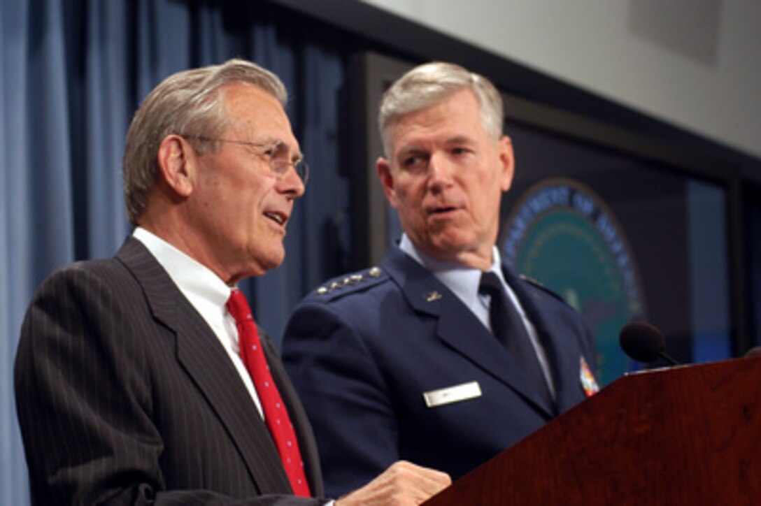 Secretary of Defense Donald H. Rumsfeld and Chairman of the Joint Chiefs of Staff Gen. Richard B. Myers, U.S. Air Force, share a light-hearted moment as they brief reporters in the Pentagon on April 25, 2003. Rumsfeld and Myers brought reporters up-to-date on coalition humanitarian operations efforts and remaining pockets of resistance in Iraq. 
