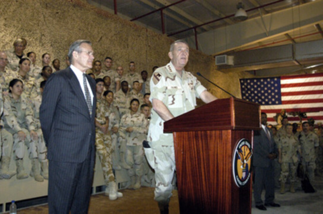 Army Gen. Tommy Franks, commander of U.S. Central Command, introduces Secretary of Defense Donald H. Rumsfeld at a town hall meeting with troops at Central Command Forward headquarters in Qatar, on April 28, 2003. Rumsfeld is visiting the troops and senior leadership in the Persian Gulf region. 