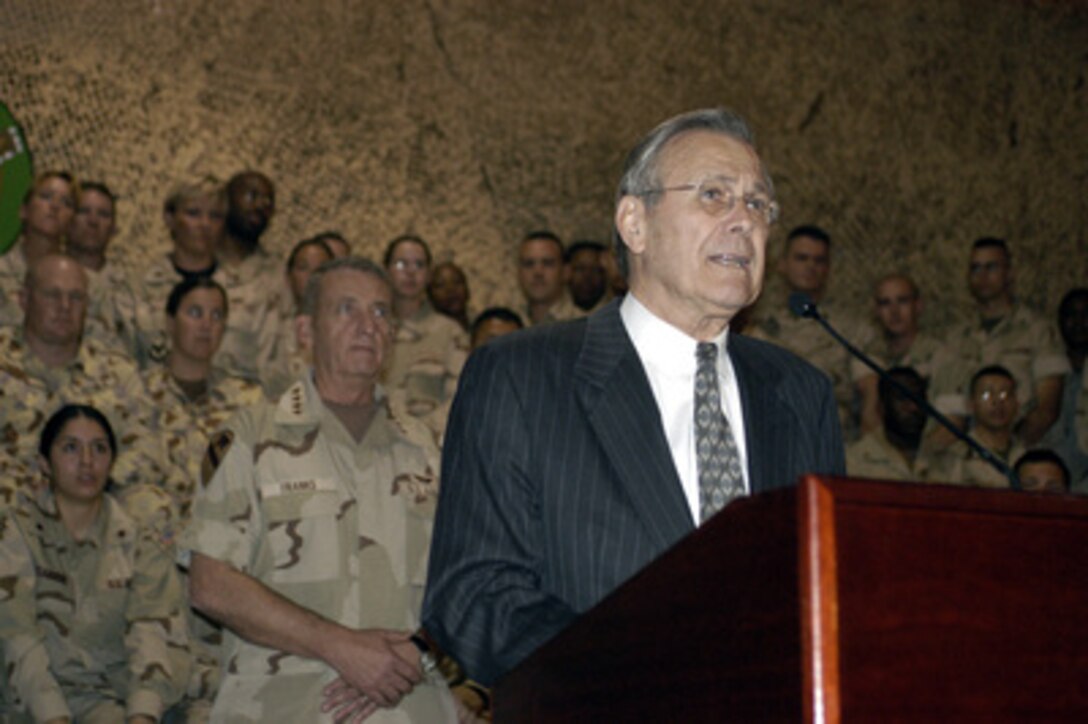 Secretary of Defense Donald H. Rumsfeld speaks to the troops at a town hall meeting at Central Command Forward headquarters in Qatar, on April 28, 2003. Rumsfeld, accompanied by Army Gen. Tommy Franks, commander of U.S. Central Command, is visiting the troops and senior leadership in the Persian Gulf region. 
