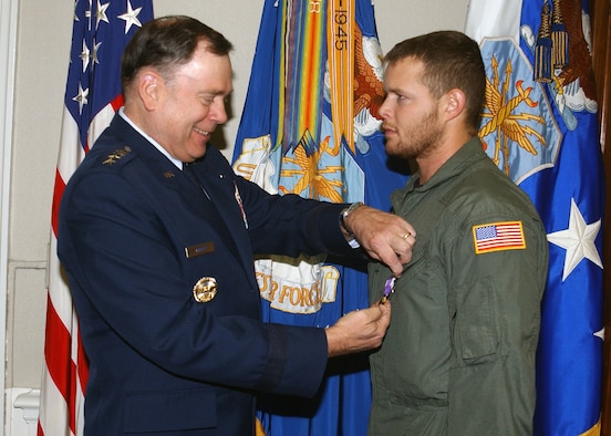 WASHINGTON (AFPN) -- Staff Sgt. Robert L. Disney Jr. receives a Purple heart from Air Force Chief of Staff Gen. John P. Jumper during a Pentagon ceremony April 30.  Disney was hit by enemy fire April 18 during a mission in support of Operation Enduring Freedom.  (U.S. Air Force photo by Larry McTighe)