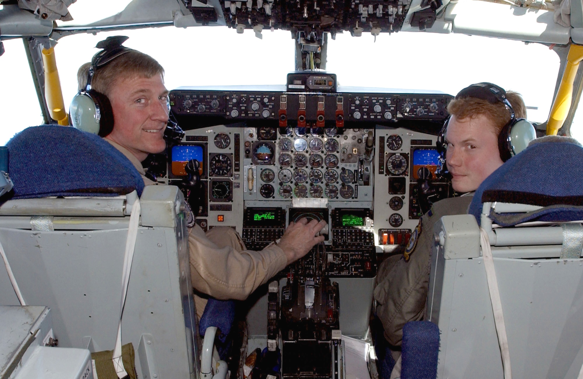 OPERATION IRAQI FREEDOM -- Col. Tony Mauer (left) and 1st Lt. Eric Adcock fly a KC-135 Stratotanker as they prepare to refuel both their brothers' aircraft.  Mauer's brother, Maj. John Mauer, is a navigator in the E-3 Sentry airborne warning and control system aircraft, and Adcock's brother, 1st Lt. Nick Adcock, is a pilot in the E-8C Joint Stars aircraft.  (U.S. Air Force photo by Master Sgt. Mark Bucher)