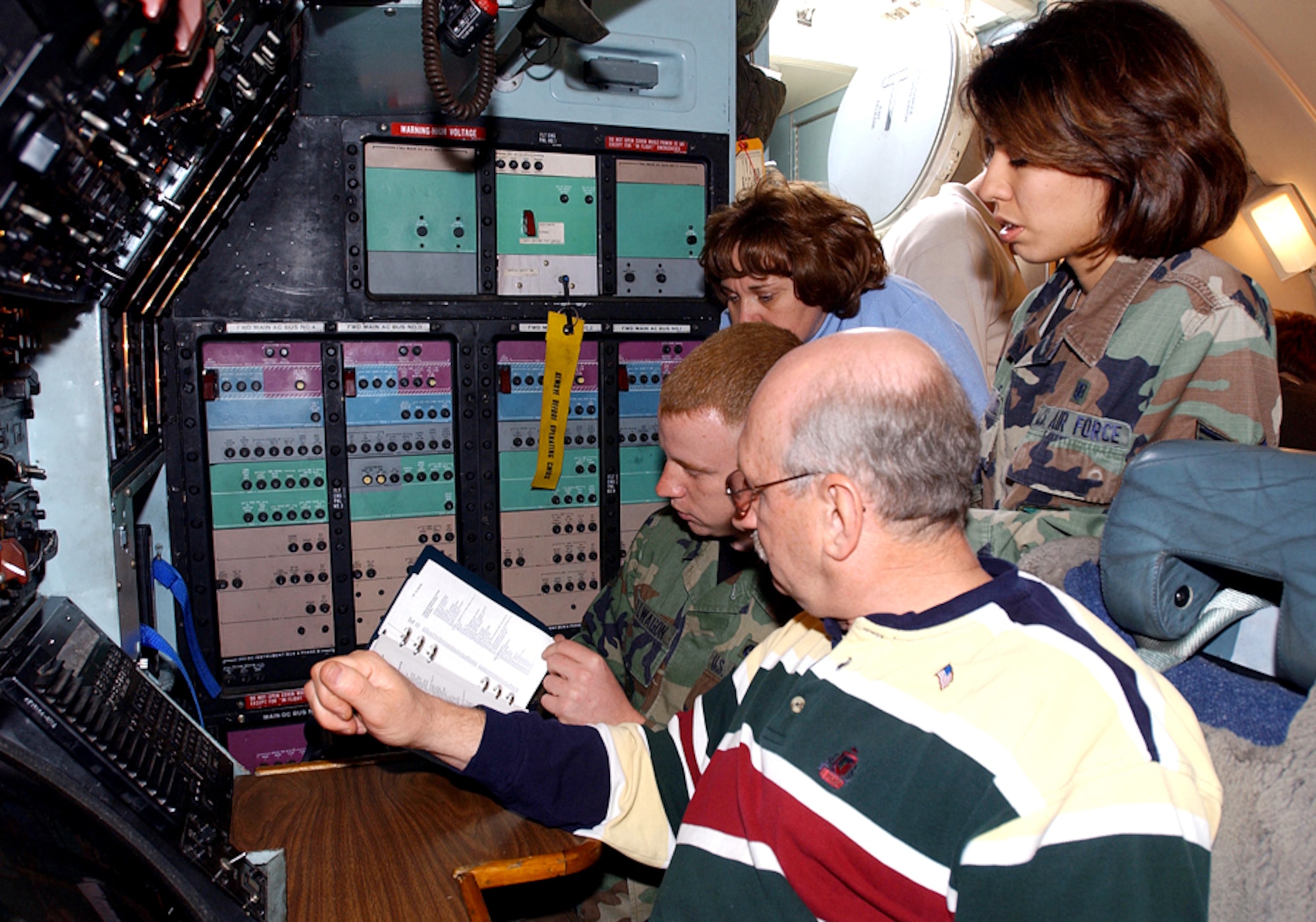DOVER AIR FORCE BASE, Del. (AFPN) -- Senior Airmen Robert and Melissa Stillwagon and Robert's parents, Robert and Bea Stillwagon, learn about the flight deck instruments of a C-5 Galaxy during Take Your Parents to Work Day here April 25.  The event was designed to give parents an inside look at base operations and the role their children play in the mission.  (U.S. Air Force photo by Kristin Royalty)