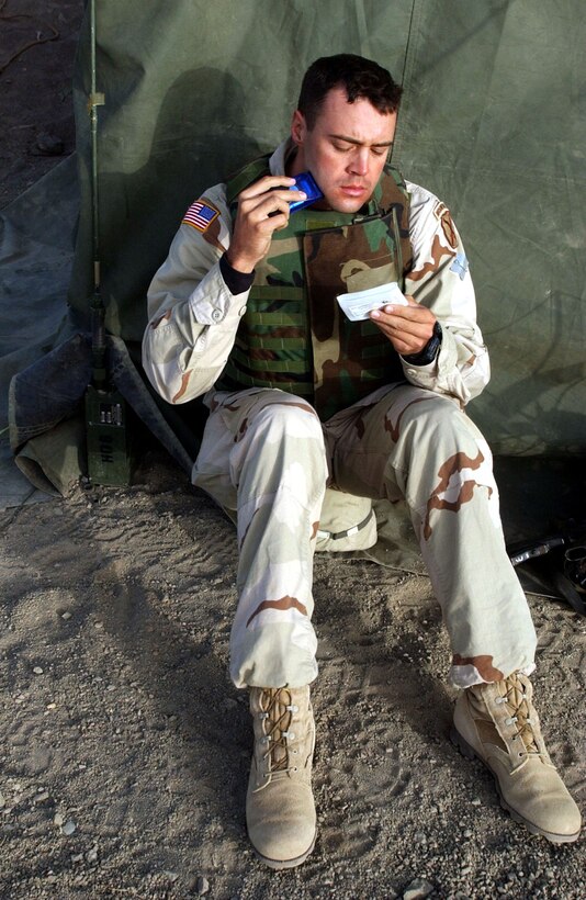 OPERATION ENDURING FREEDOM -- Capt. Danny Stout, an air liaison officer deployed with the Army's 2-505 Parachute Infantry Regiment of the 82nd Airborne Division, uses his signaling mirror for a quick shave the morning after air-assaulting into a hostile area in the mountains of Afghanistan.  Stout, a B-52 Stratofortress pilot serving a two-year tour with the Army, uses the same mirror to signal coalition aircraft on close-air support missions. (U.S. Air Force photo by Staff Sgt. Russell Wicke)