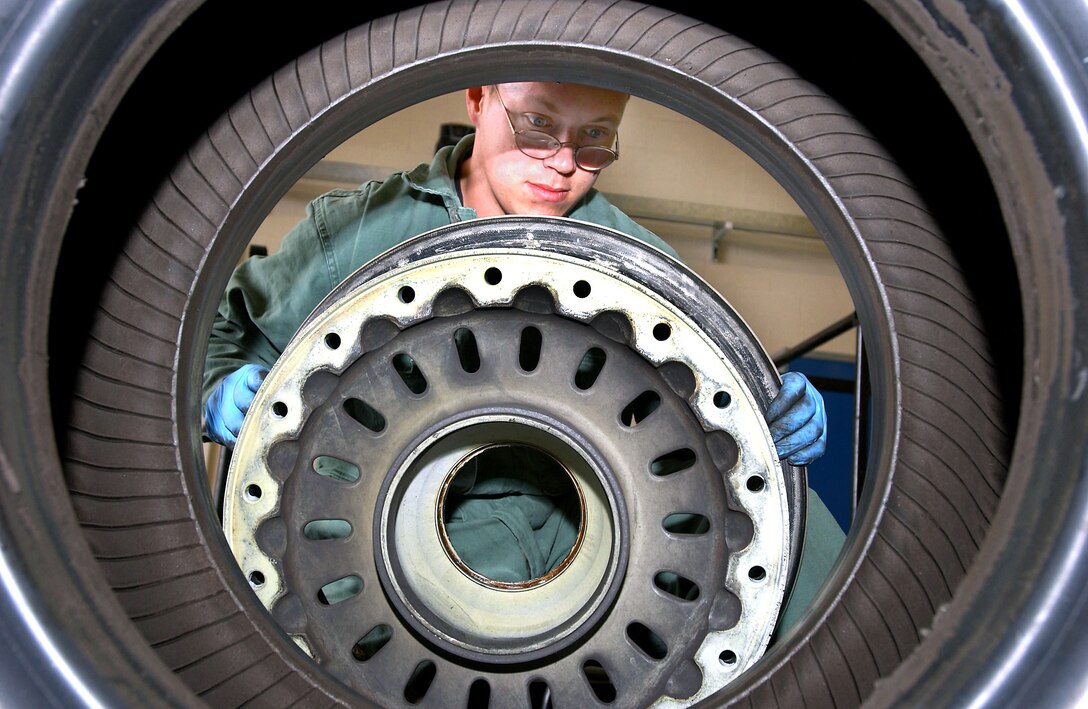 ROYAL AIR FORCE LAKENHEATH, England -- Senior Airman James Carey removes a KC-135R Stratotanker wheel from the tire.  His wheel and tire section here serves as the regional repair facility for all European, in-transient and Southwest Asian theaters.  Carey is deployed to RAF Lakenheath from the 319th Maintenance Squadron at Grand Forks Air Force Base, N.D.  (U.S. Air Force photo by Airman 1st Class Franklin J. Perkins)