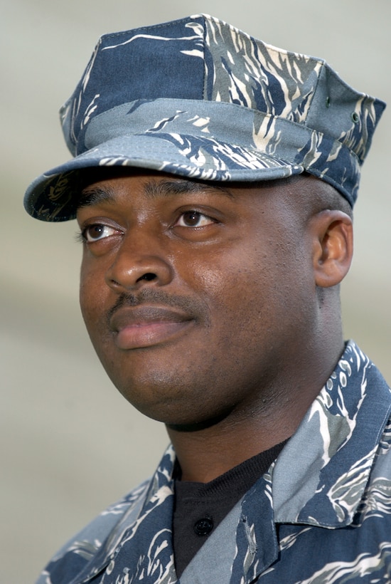 WASHINGTON (AFPN) -- Staff Sgt. Daryl Alford dons the test Air Force utility uniform in the Pentagon’s courtyard.  The blue, gray and green tiger-stripe camouflage ensemble includes many new features intended to increase functionality while providing a distinctive look for the 21st century airmen.  The uniforms will undergo wear-testing beginning in January 4.  Airmen from a cross section of Air Force career fields will provide feedback on the fit, durability and functionality of the proposed ensemble which will come in men's and women's cuts.  (U.S. Air Force photo by Master Sgt. Jim Varhegyi) 
