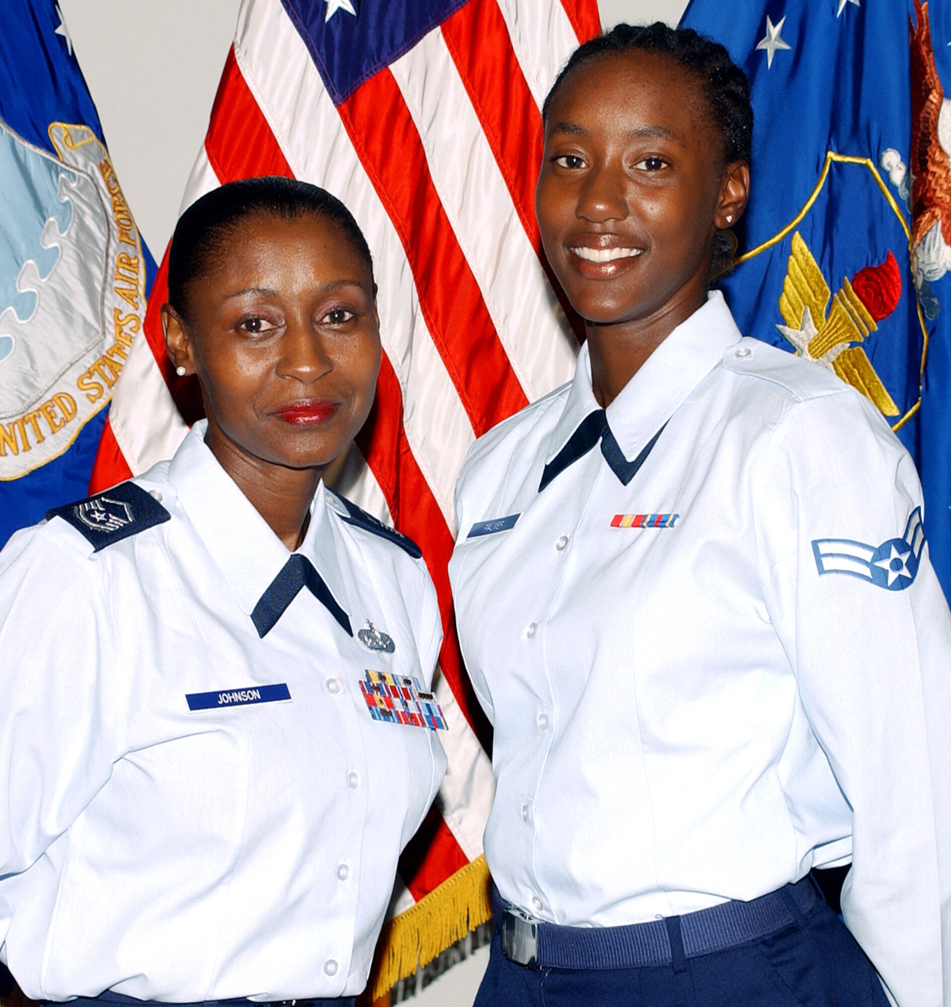 RANDOLPH AIR FORCE BASE, Texas (AFPN) -- Master Sgt. Sharita Johnson (left) and her daughter, Airman 1st Class Kareema Palmer-Johnson, were promoted together Aug. 1. (U.S. Air Force photo by Joel Martinez)