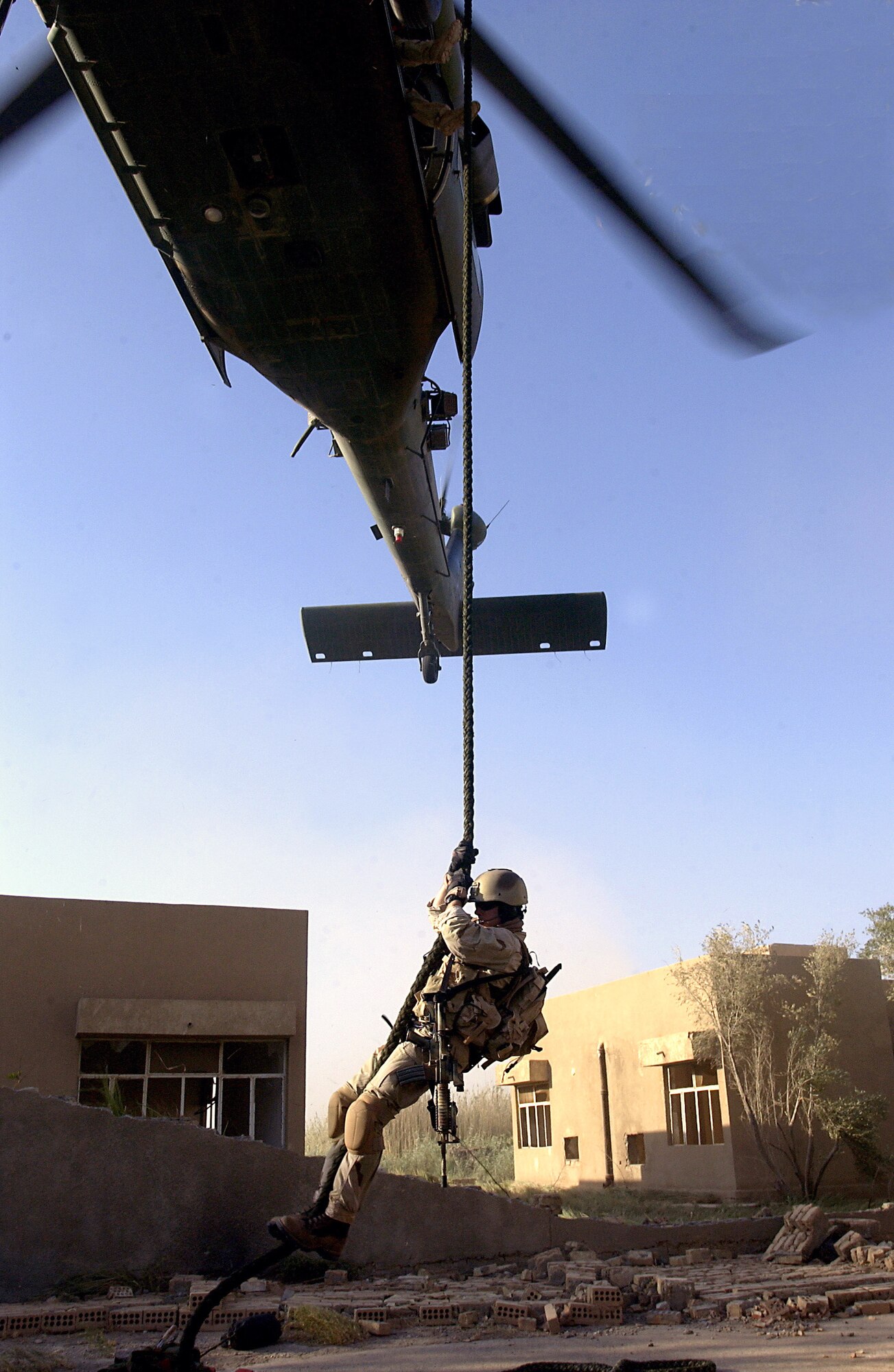 OPERATION IRAQI FREEDOM -- A pararescueman drops in on a rope from an HH-60G Pave Hawk helicopter during a Combat Search and Rescue exercise. The exercise was designed to hone the skills of a CSAR team supporting Operation Iraqi Freedom. (U.S. Air Force photo by Master Sgt. Robert R. Hargreaves Jr.)