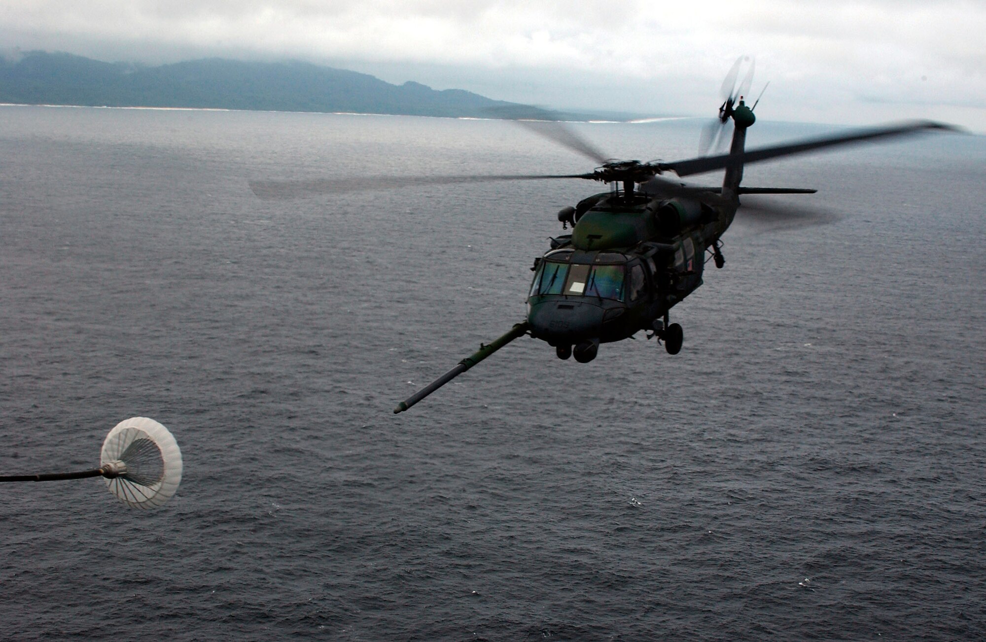 OVER THE ATLANTIC OCEAN - An HH-60G Pave Hawk helicopter prepares for aerial refueling from an MC-130P Combat Shadow after a mission into the U.S. Embassy in Liberia Aug. 6.  (U.S. Air Force photo by Tech. Sgt. Justin D. Pyle)