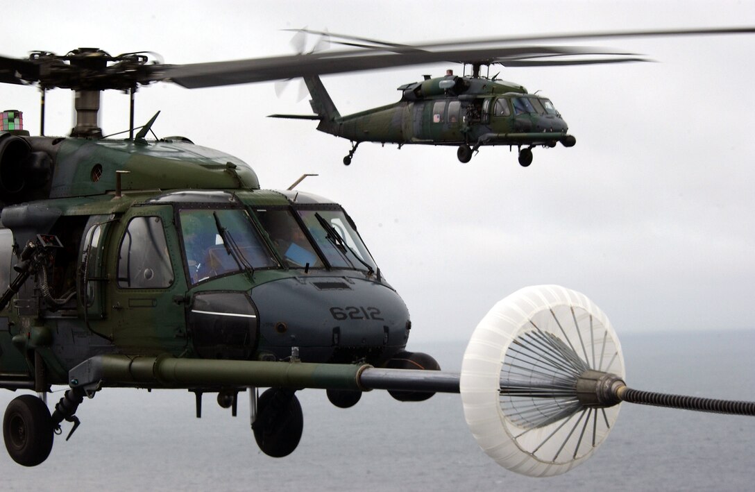 OVER THE ATLANTIC OCEAN -- An HH-60G Pave Hawk helicopter takes on fuel from an MC-130P Combat Shadow after a mission into the U.S. Embassy in Liberia Aug. 6.  (U.S. Air Force photo by Tech. Sgt. Justin D. Pyle)