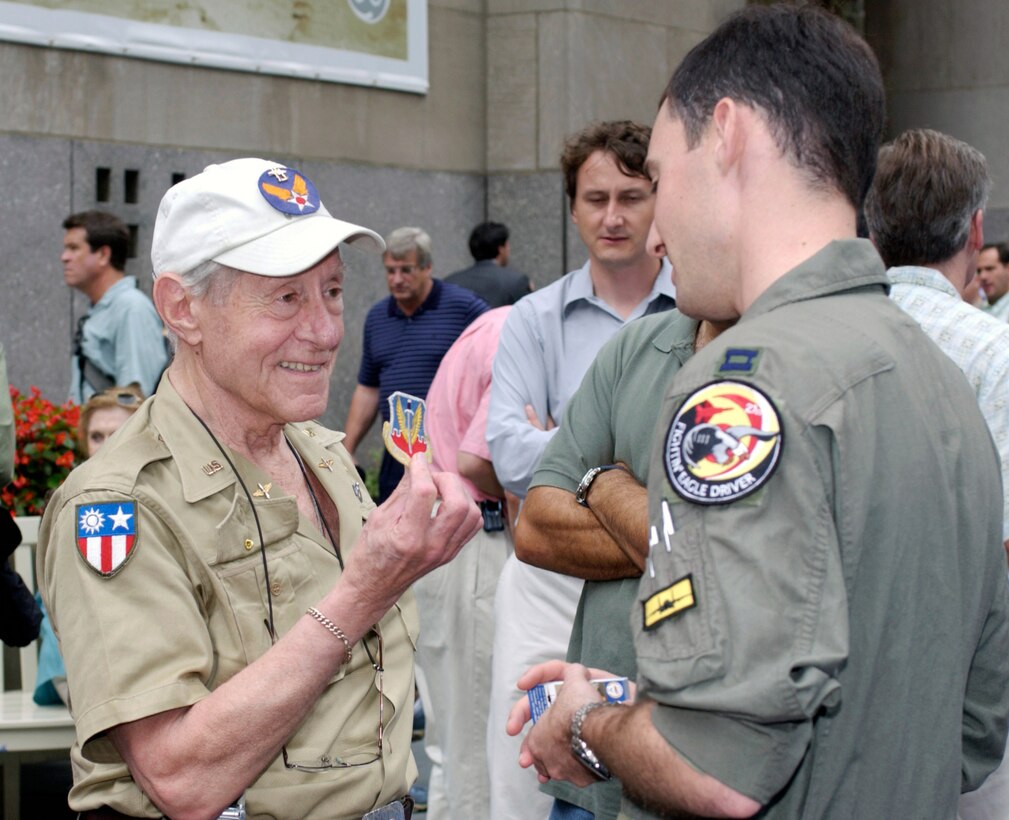 NEW YORK -- Arthur Lasker, a World War II veteran and P-38 Lightning pilot, talks to Capt. David Shachter during a Centennial of Flight celebration Aug. 8 at Rockefeller Center here.  Shachter is an F-15 Eagle pilot assigned to the 27th Fighter Squadron at Langley Air Force Base, Va.  (U.S. Air Force photo by Staff Sgt. A.J. Bosker)