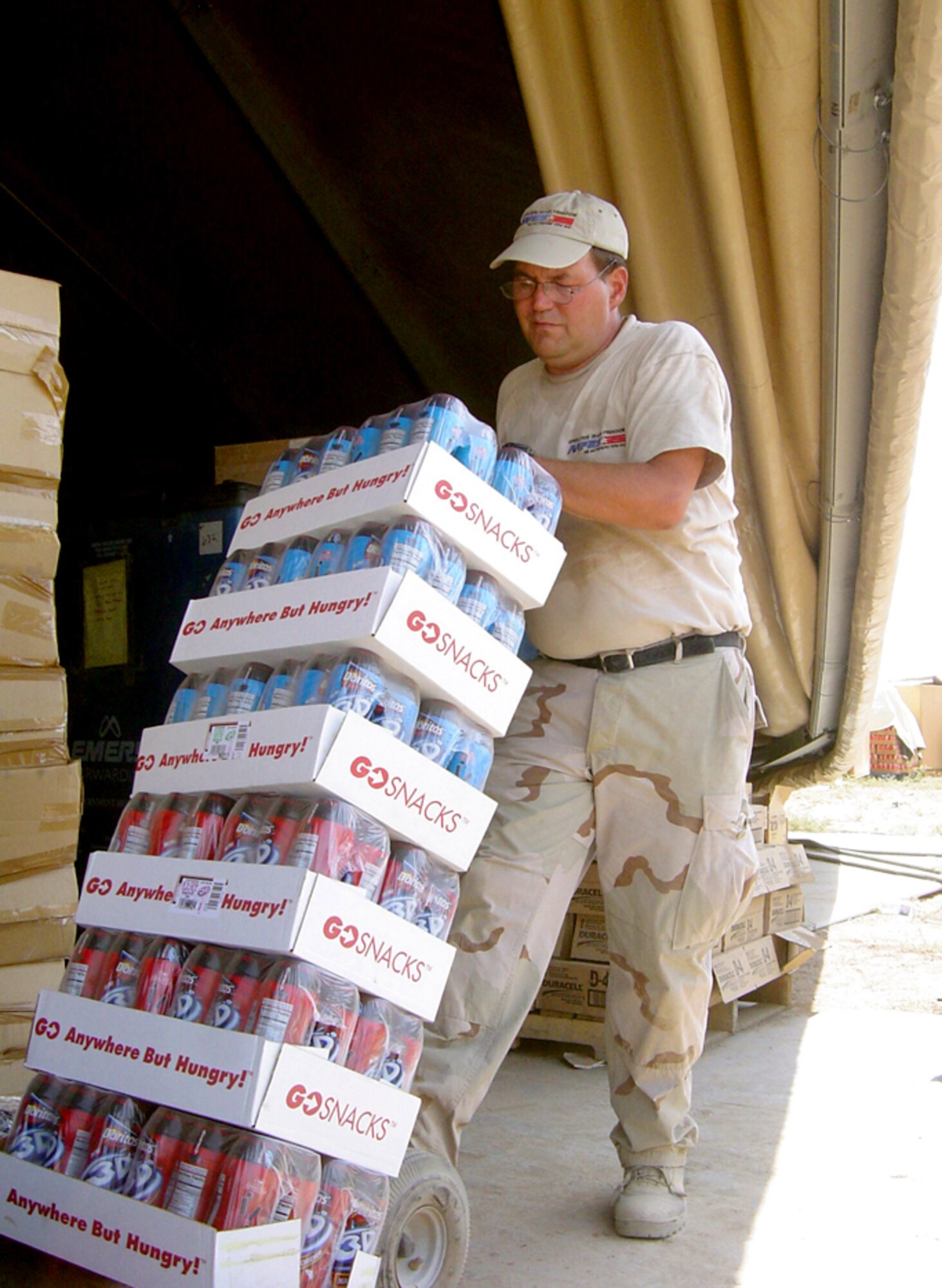 KIRKUK AIR BASE, Iraq -- Tom Williams prepares to restock snacks in the base exchange here.  He is an Army and Air Force Exchange Service sales area manager from Robins Air Force Base, Ga.  Williams has been assigned here since June.  (U.S. Air Force photo by Tech. Sgt. Mark Getsy)