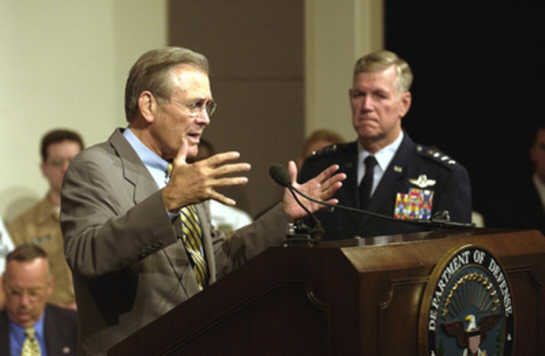 Secretary of Defense Donald H. Rumsfeld answers a question from the audience at a town hall meeting in the Pentagon auditorium on Aug. 14, 2003. Rumsfeld and Chairman of the Joint Chiefs of Staff Gen. Richard B. Myers, U.S. Air Force, delivered opening remarks then fielded questions from military and civilian Pentagon employees. The forum allows people in the Pentagon to direct their questions to the leadership at the Defense Department. 